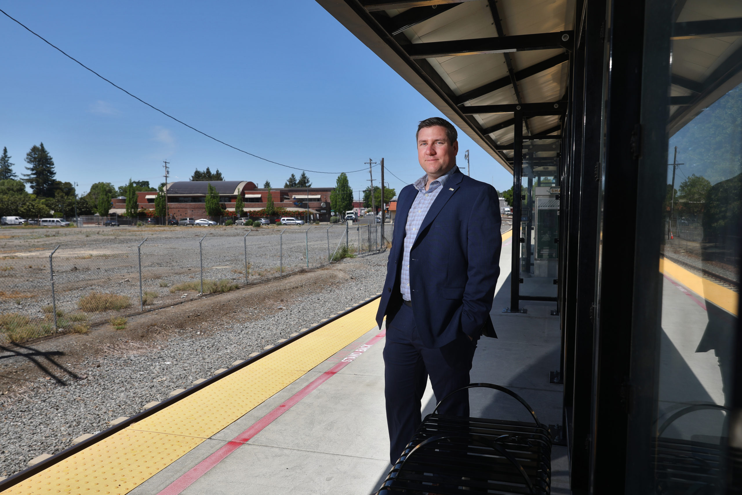 Santa Rosa Mayor Chris Rogers stands on the SMART platform in Railroad Square. SMART has sold the land on the west side of the tracks for future housing development. (Christopher Chung/ The Press Democrat)