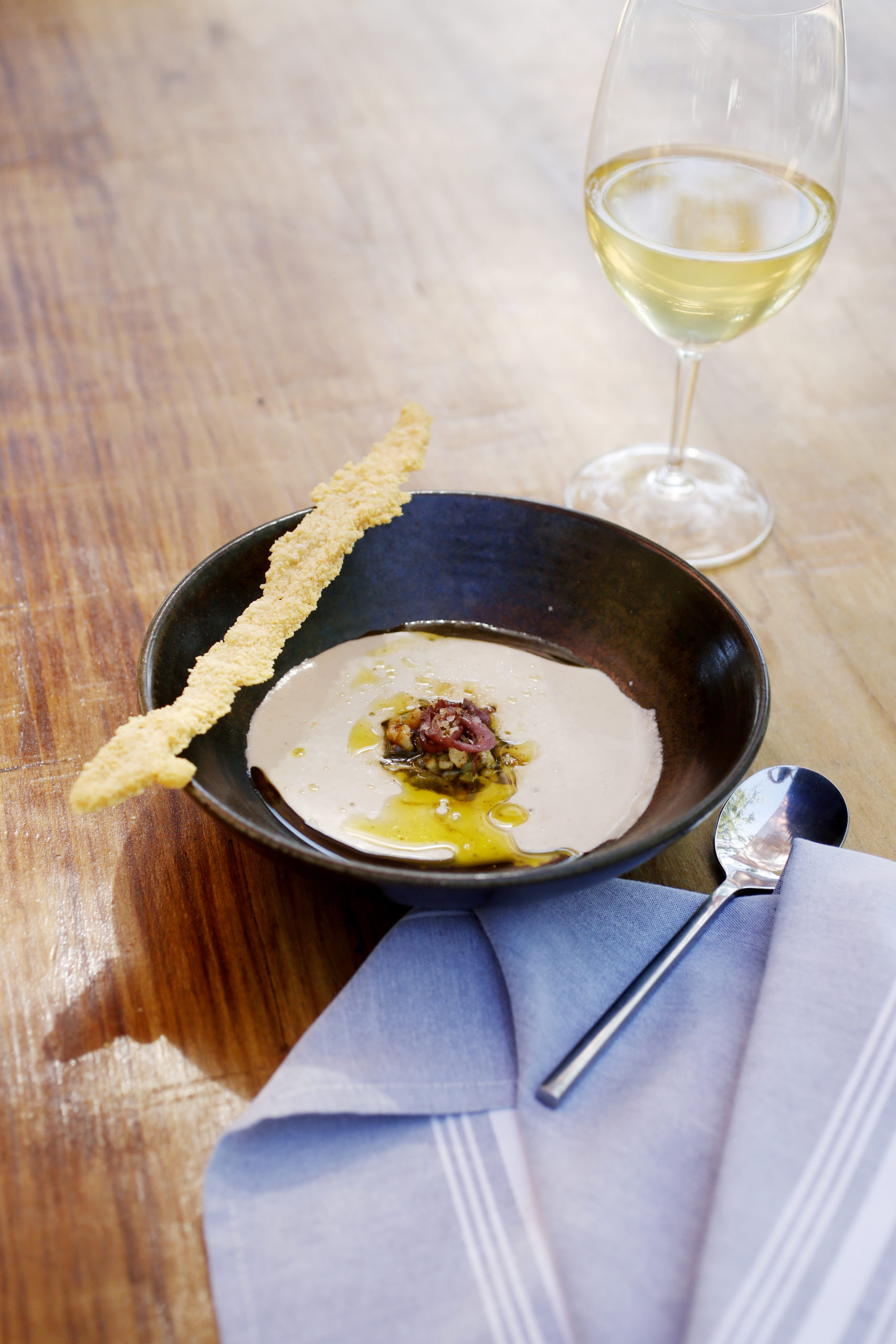 A white gazpacho made with walnuts, cucumbers, grapes, onions, garlic and olive oil by Executive Chef Oscar Bendeck at Kivelstadt Cellars Wine Garden and Eatery in Sonoma, Calif., on Thursday, July 8, 2021.(Beth Schlanker/The Press Democrat)