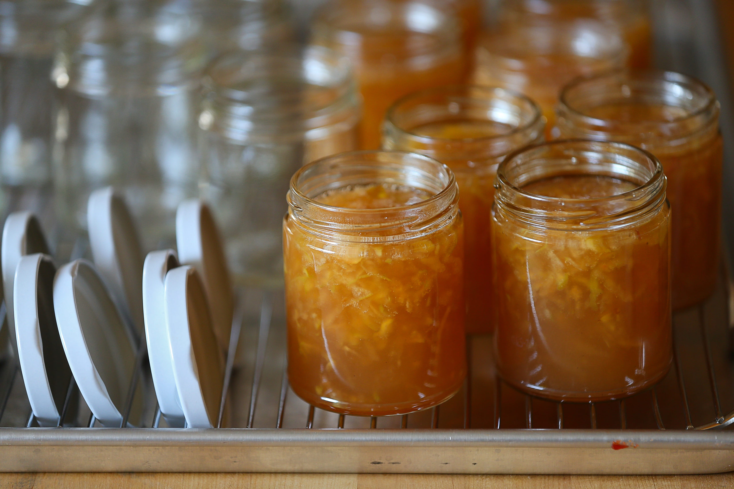 Freshly made Fourteen Magpies Handmade Jams & Preserves Gravenstein Apple Jelly waits to be sealed in jars in Santa Rosa on Wednesday, July 28, 2021. (Christopher Chung/ The Press Democrat)