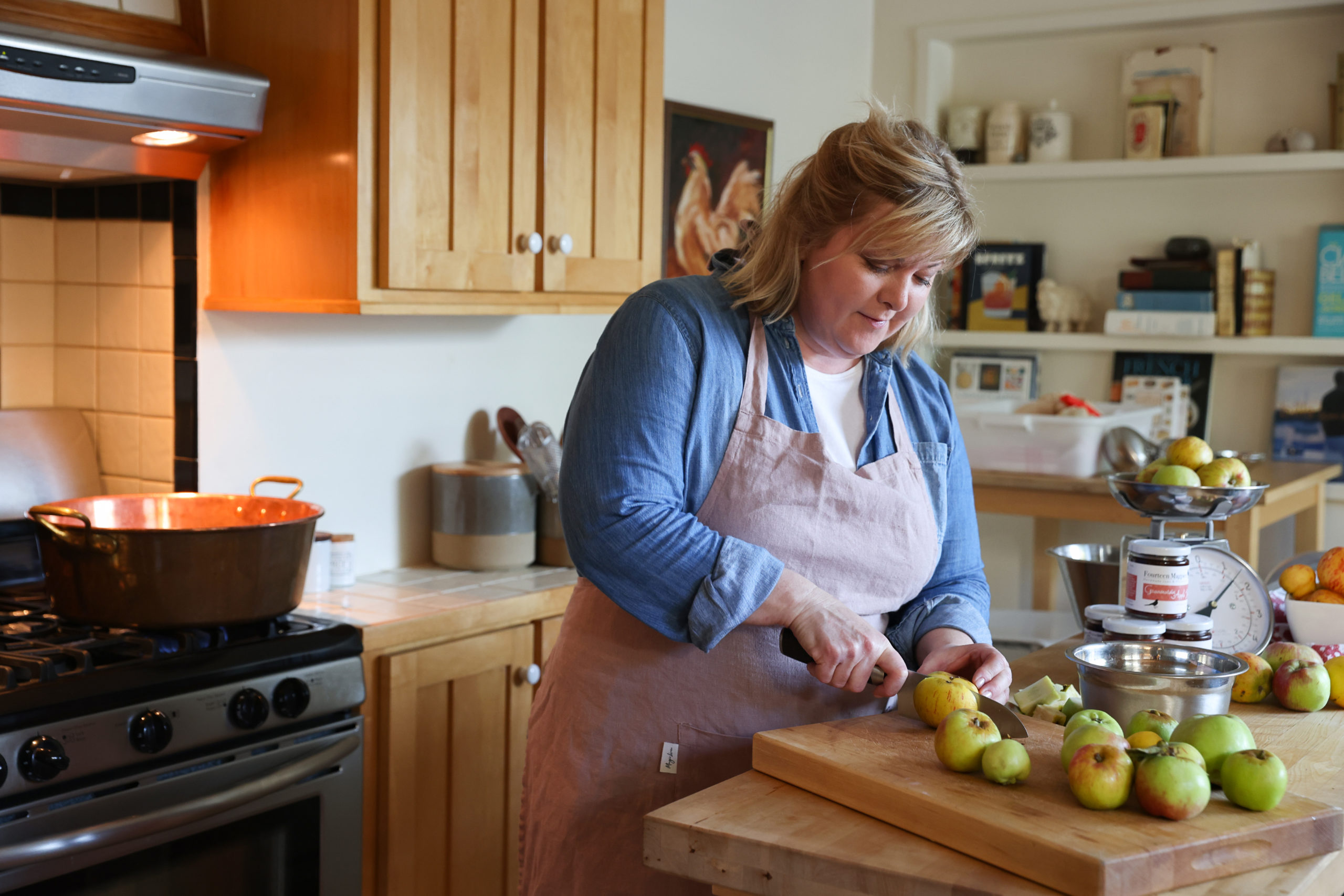 Fourteen Magpies Handmade Jams & Preserves owner and chief jammer Tanya Seibold cuts Gravenstein for making jelly in Santa Rosa on Wednesday, July 28, 2021. (Christopher Chung/ The Press Democrat)