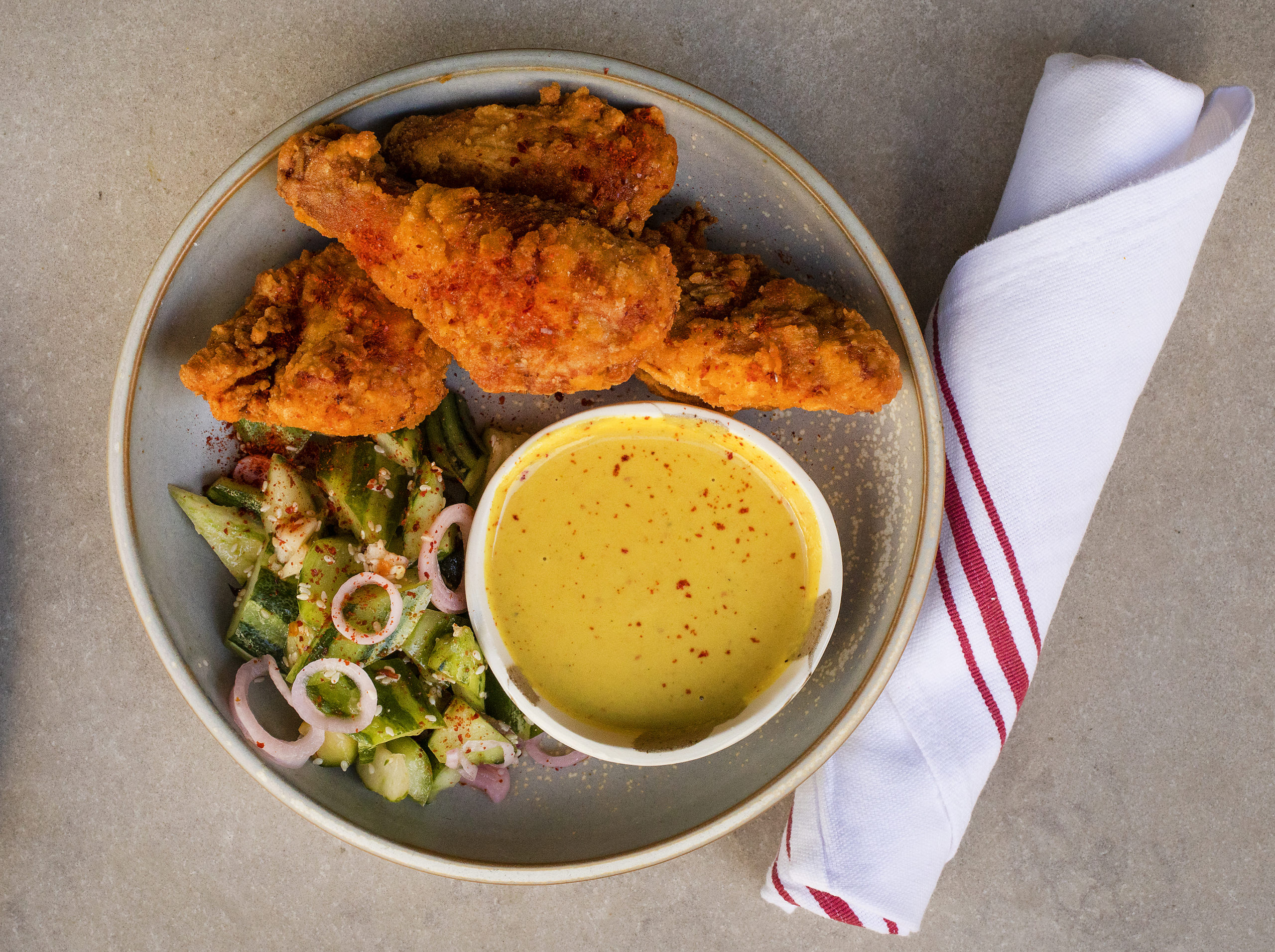 Fried chicken with cucumber and coconut peanut curry from Valley Bar + Bottle on the Sonoma square. (John Burgess/The Press Democrat)