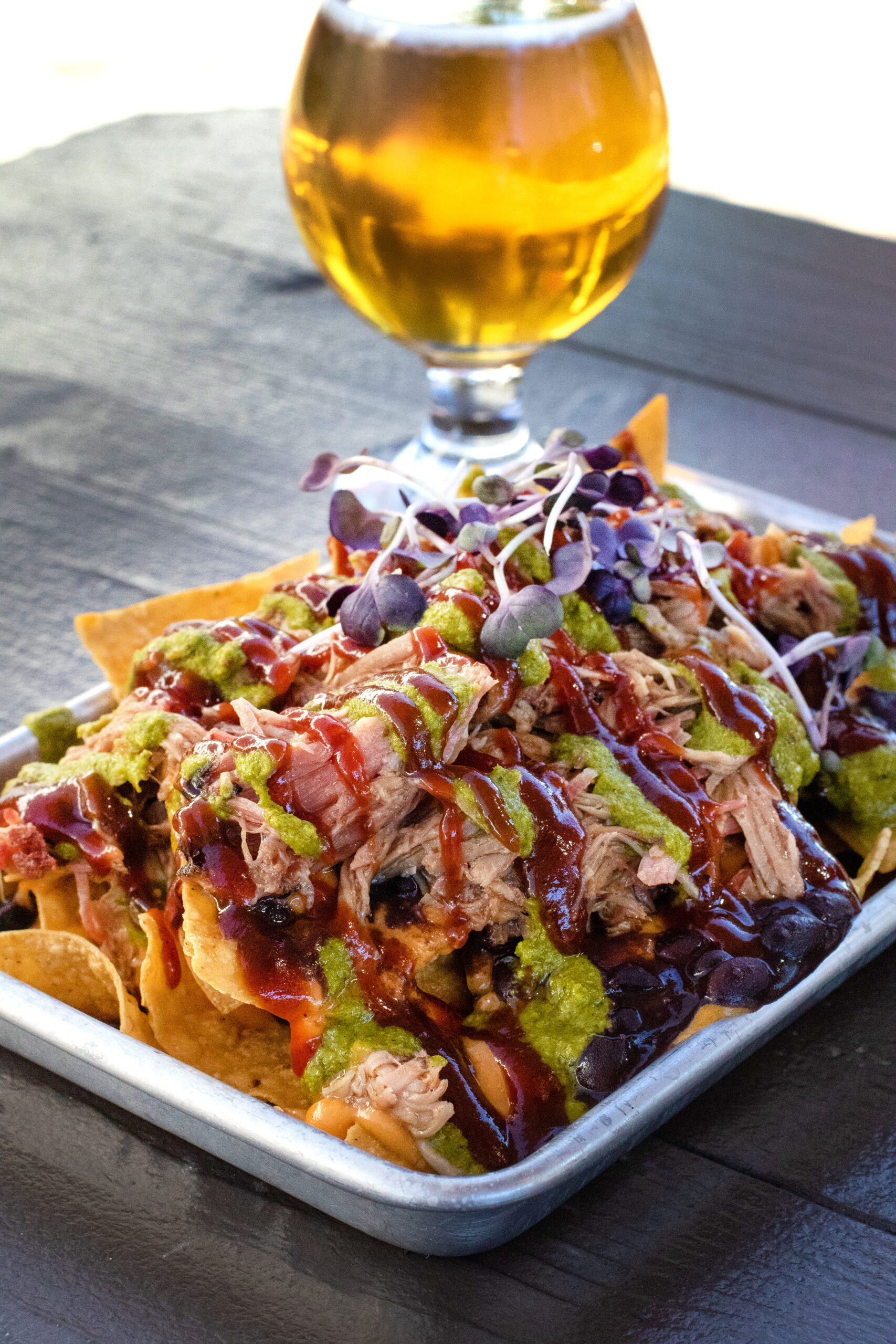 Barbecue nachos with pulled pork, nacho cheese, barbecue sauce, black beans and chimmichurri at Austin's Barbecue at Old Possum Brewing in Santa Rosa. (Heather Irwin/Sonoma Magazine)