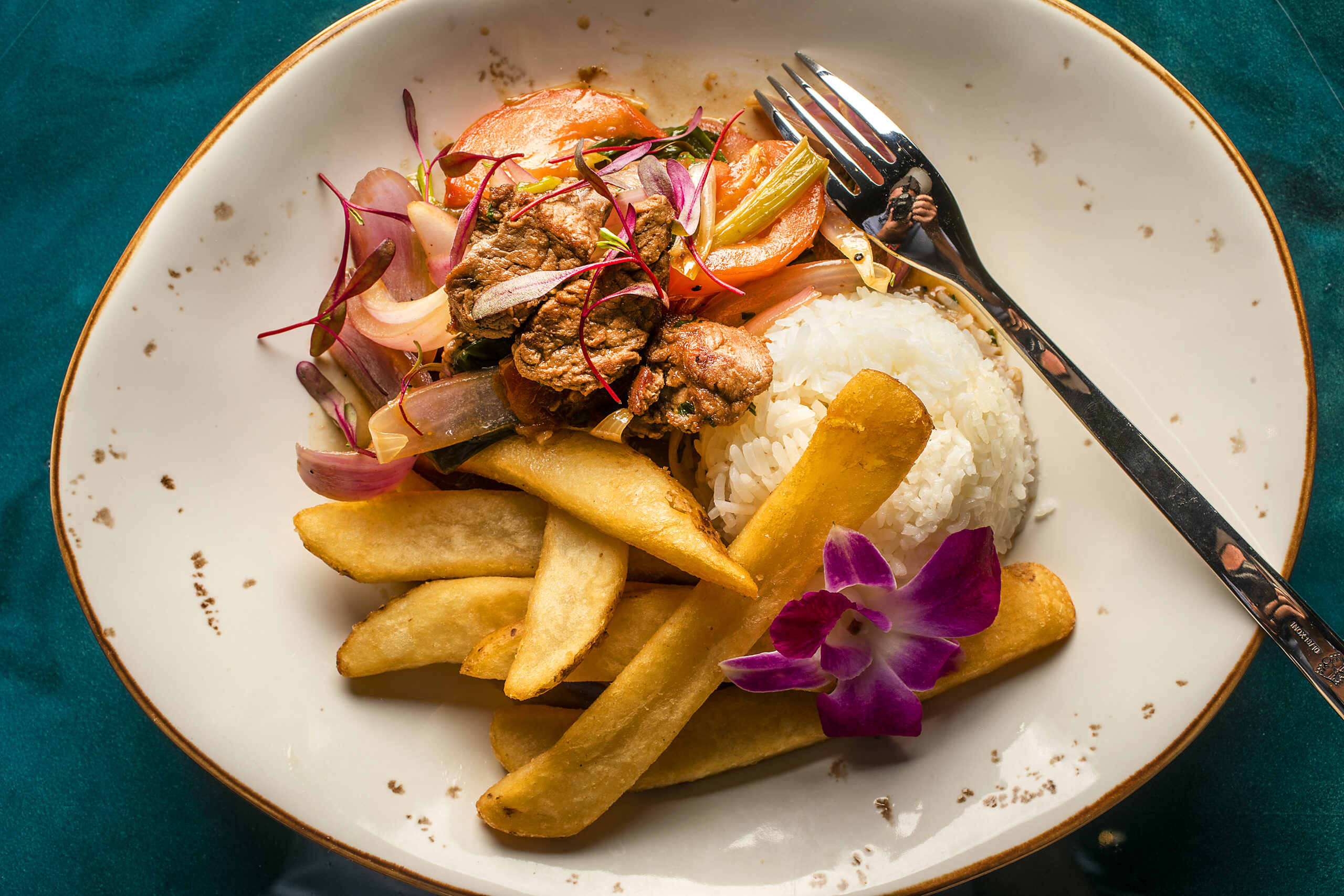 Lomo Saltado Clásico, traditional Peruvian style beef tenderloin with red onion, tomatoes, cilantro, garlic, soy and oyster sauce, french fries and rice, from Warike Restobar in downtown Santa Rosa. (John Burgess / The Press Democrat)