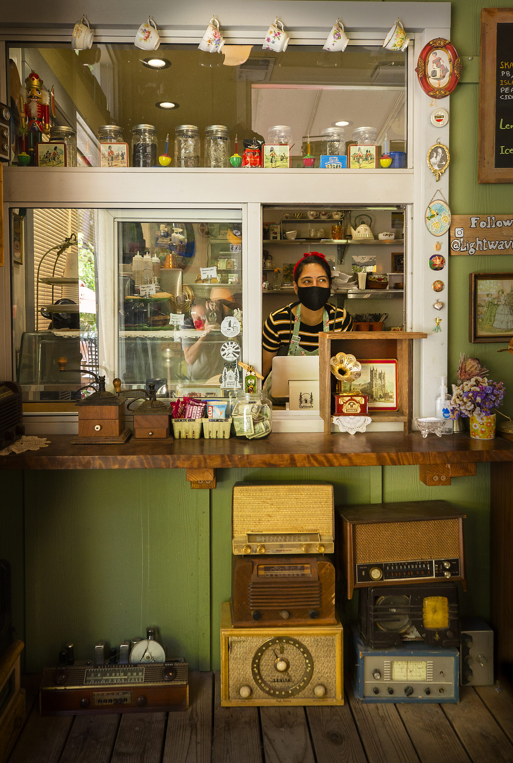 Co-owner Gal Ginzburg will take your order among the antique radios at the Lightwave Cafe at Creekside Park in Monte Rio. (John Burgess/The Press Democrat)