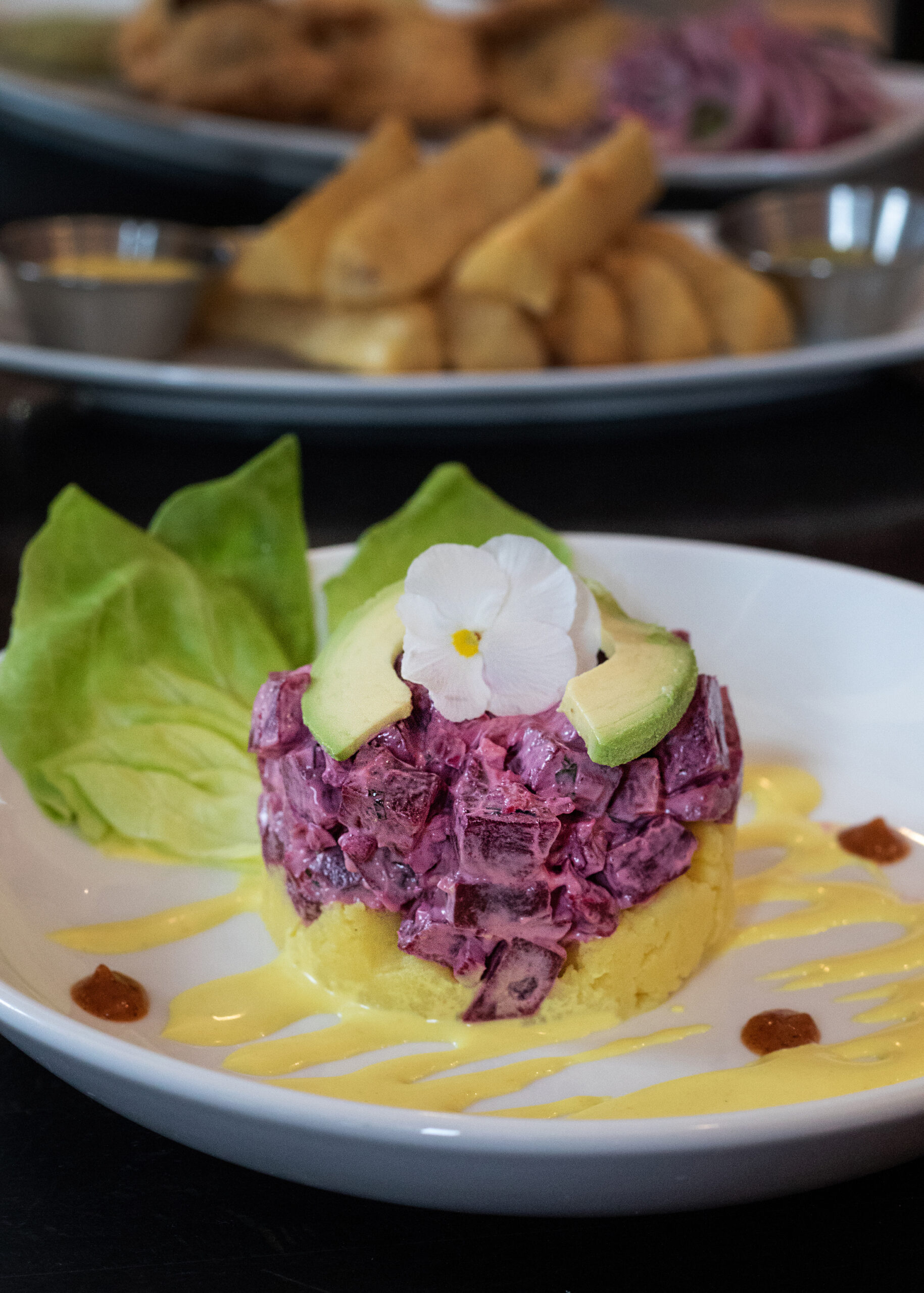 Causa Santa Rosa, : This take on the classic Causa De Pollo. Tart pickled beets in ginger, lime and cilantro sauce sit atop a cake of aji amarillo spiked mashed potatoes. Both beautiful and addictive. (Heather Irwin/Sonoma Magazine)