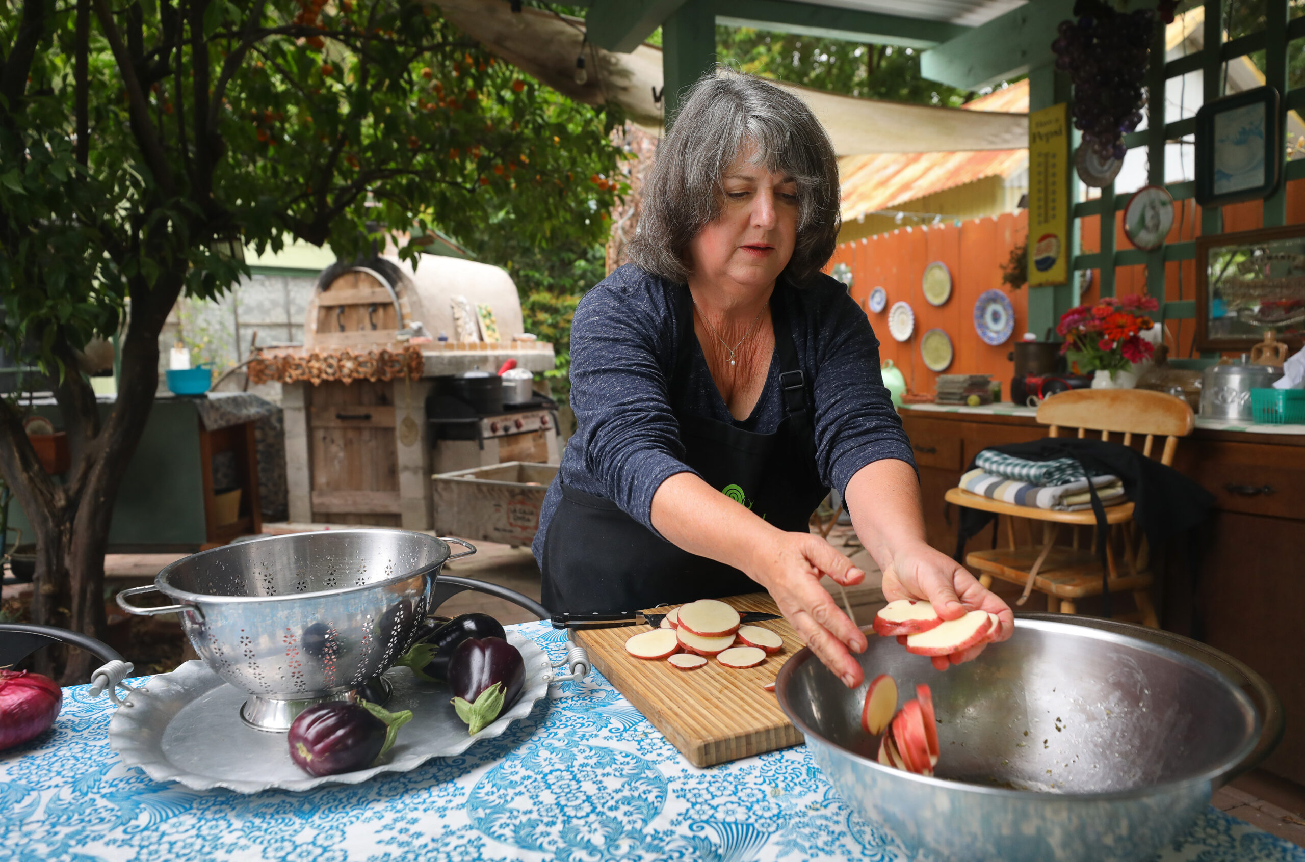 Marie Giacalone, a member of Slow Food Sonoma County North, slices Bodega Red heirloom potatoes, grown in her garden, while preparing her Bodega Red and eggplant al forno dish in Cloverdale on Wednesday, September 2, 2020. (Christopher Chung/ The Press Democrat)