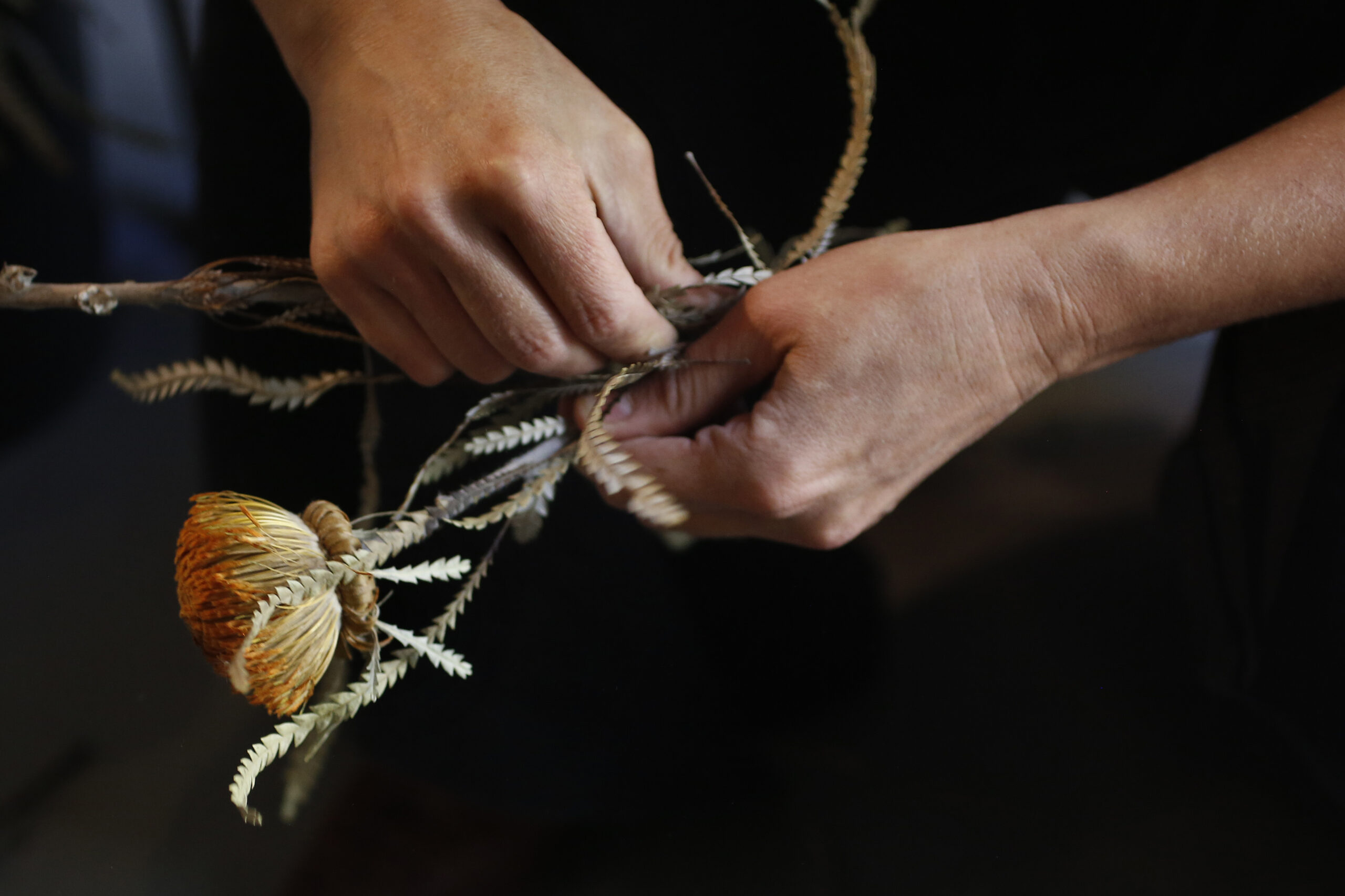 Tali Bouskila, owner of Flower Casita, uses dried Banksia formosa in a wreath at her shop in Petaluma. (Beth Schlanker/The Press Democrat)