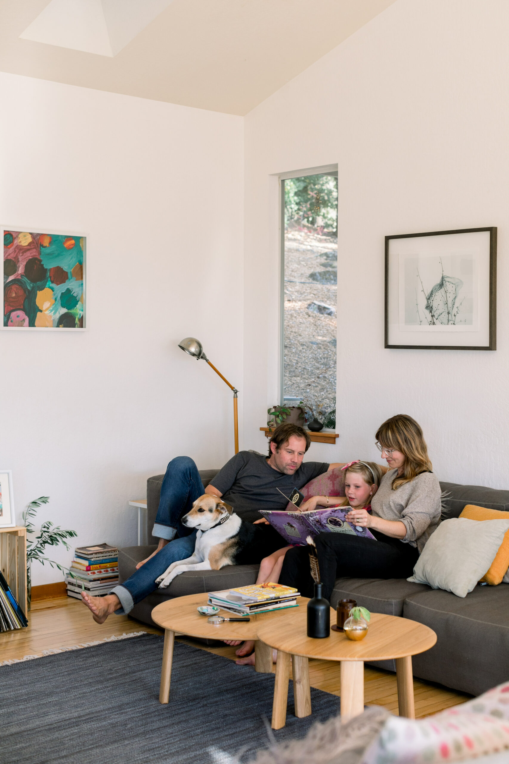 The family snuggles with dog Nori in the main living area. (Eileen Roche/for Sonoma Magazine)