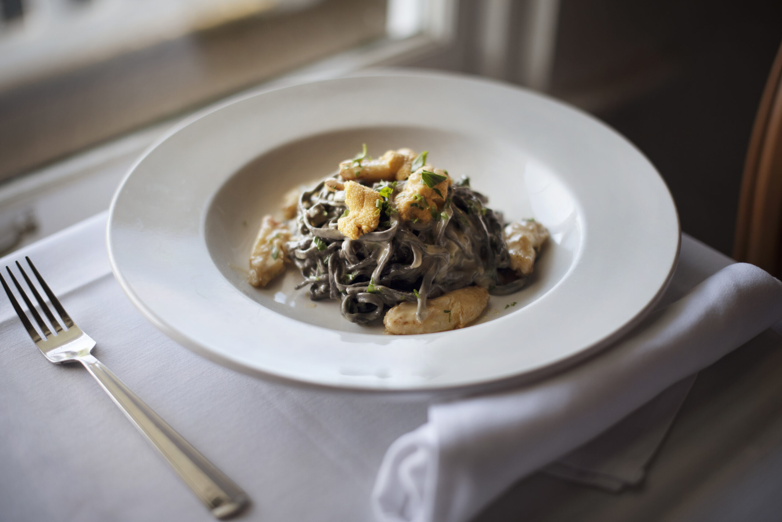 Chef de Cuisine Jason AzevedoÕs pasta with purple sea urchins and Dungeness crab at Little River Inn Restaurant in Little River, California. September 22, 2021. (Photo: Erik Castro/for Sonoma Magazine)