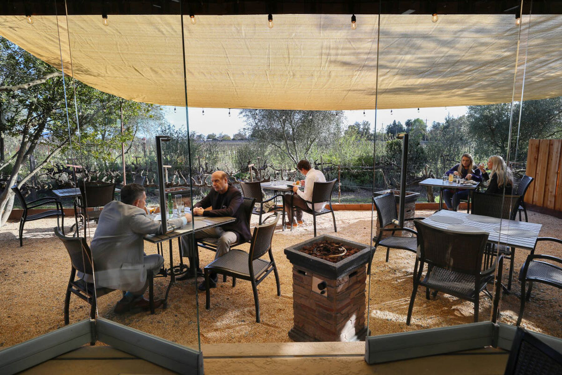 Diners occupy the new patio area installed at John Ash & Co. restaurant in Santa Rosa on Tuesday, March 23, 2021. The patio occupies an area that was formerly an herb garden, and was built to accommodate outdoor dining due to the coronavirus pandemic dining restrictions. (Christopher Chung/The Press Democrat)