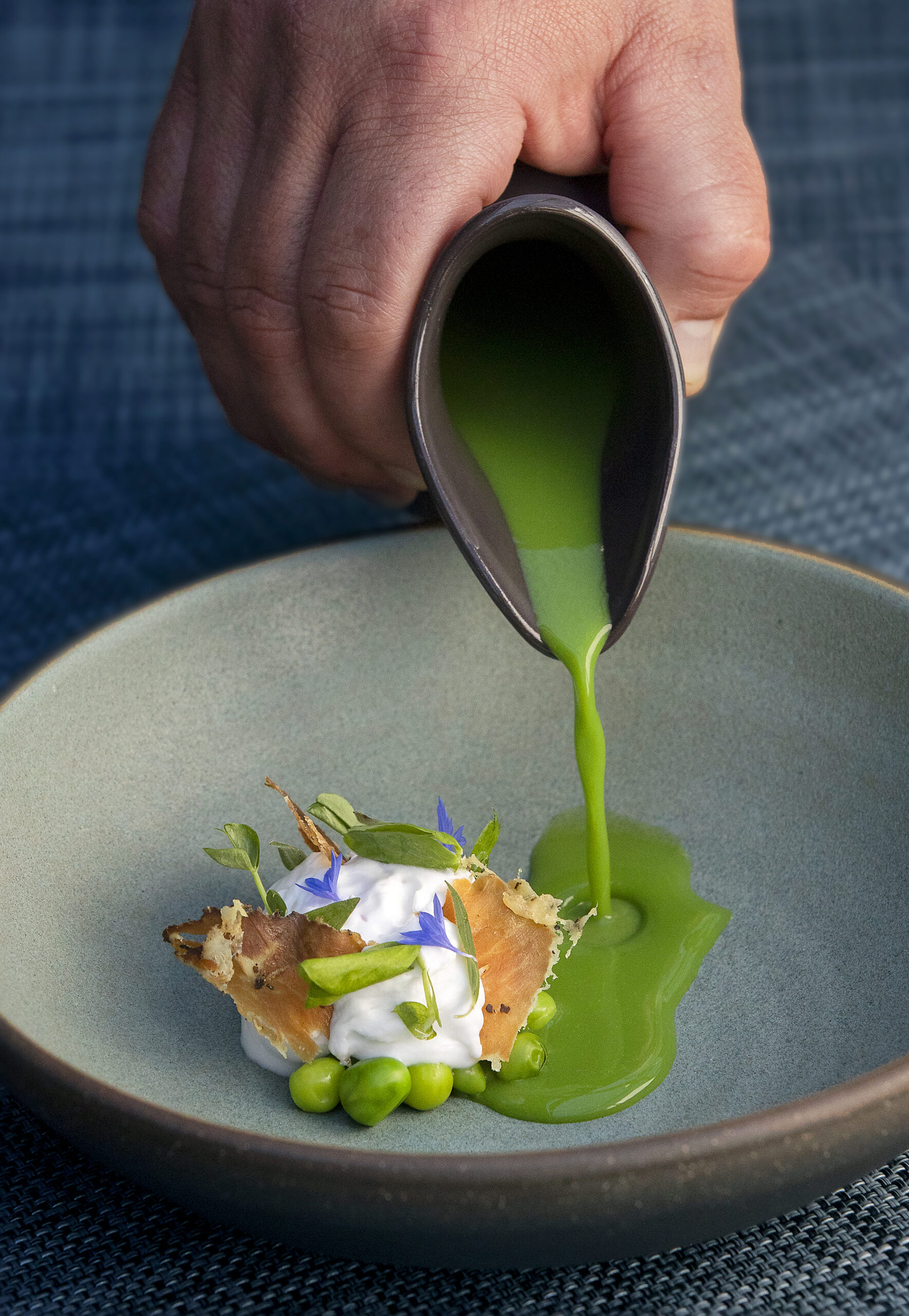 English Pea Soup poured at the table over lavender, coconut yogurt and vintner's coppa from Hazel Hill at Montage Healdsburg. (Photo by John Burgess/The Press Democrat)