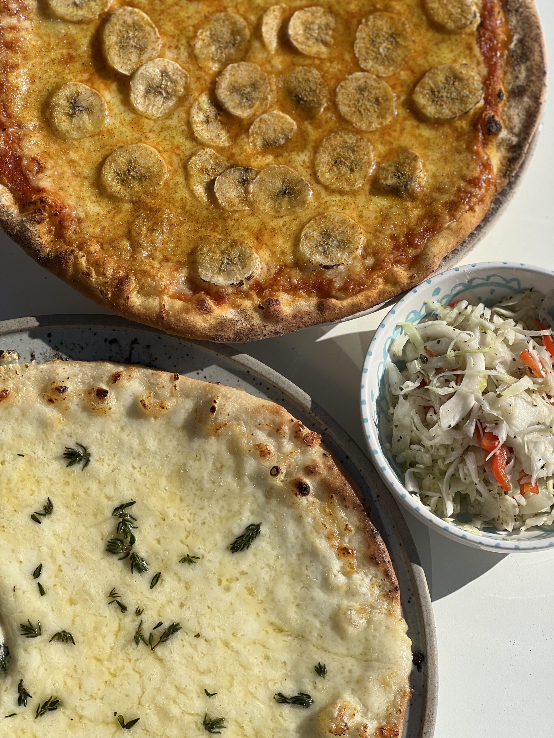 Banana Curry pizza and Pizza Bianco at Stockhome restaurant in Petaluma. (Courtesy of Stockhome)