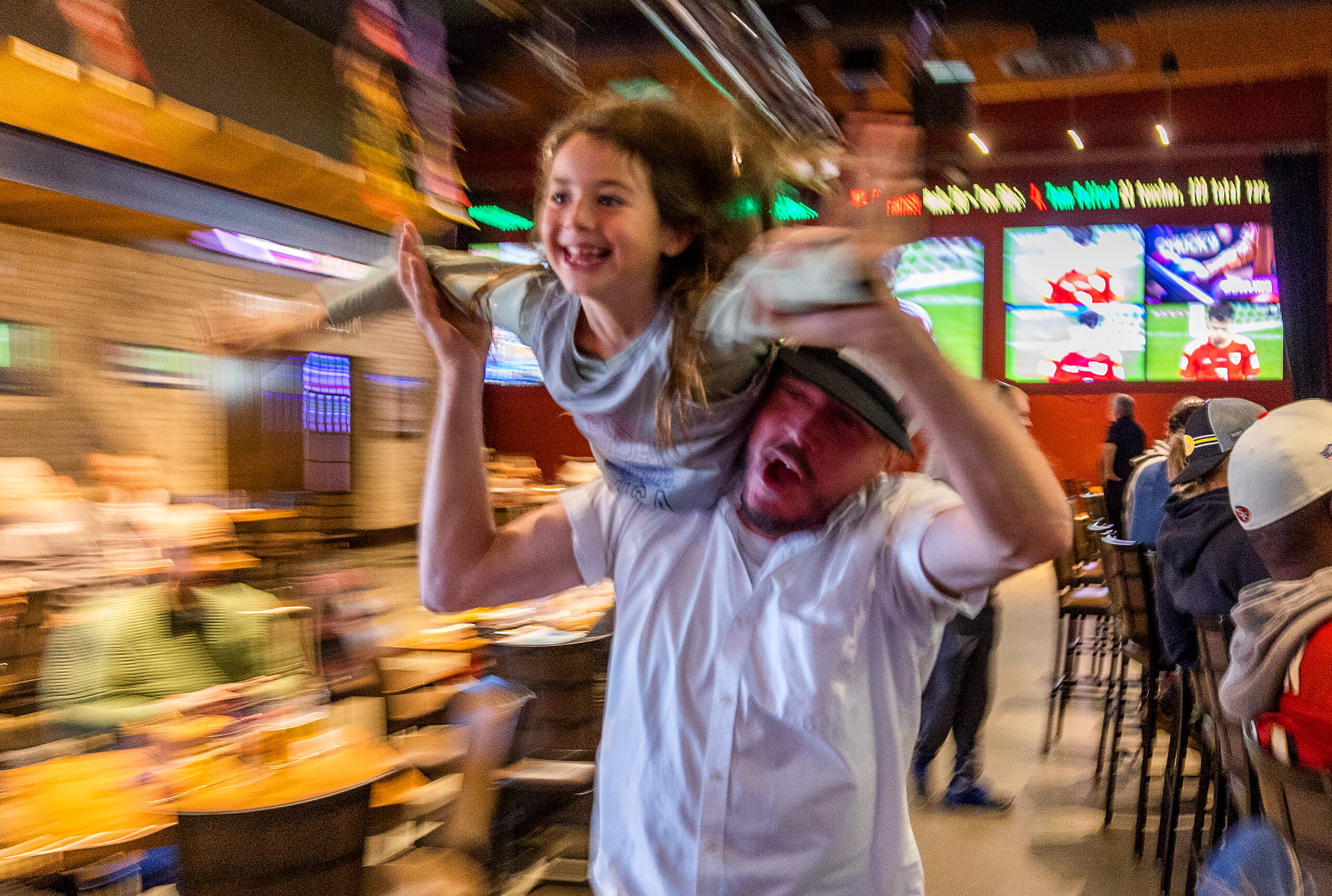 Matt Carlson gives Taylor Barlow, 7, a flying victory lap after a U.S. first half goal against Wales in the first round of the World Cup at the Victory House in Epicenter Santa Rosa
