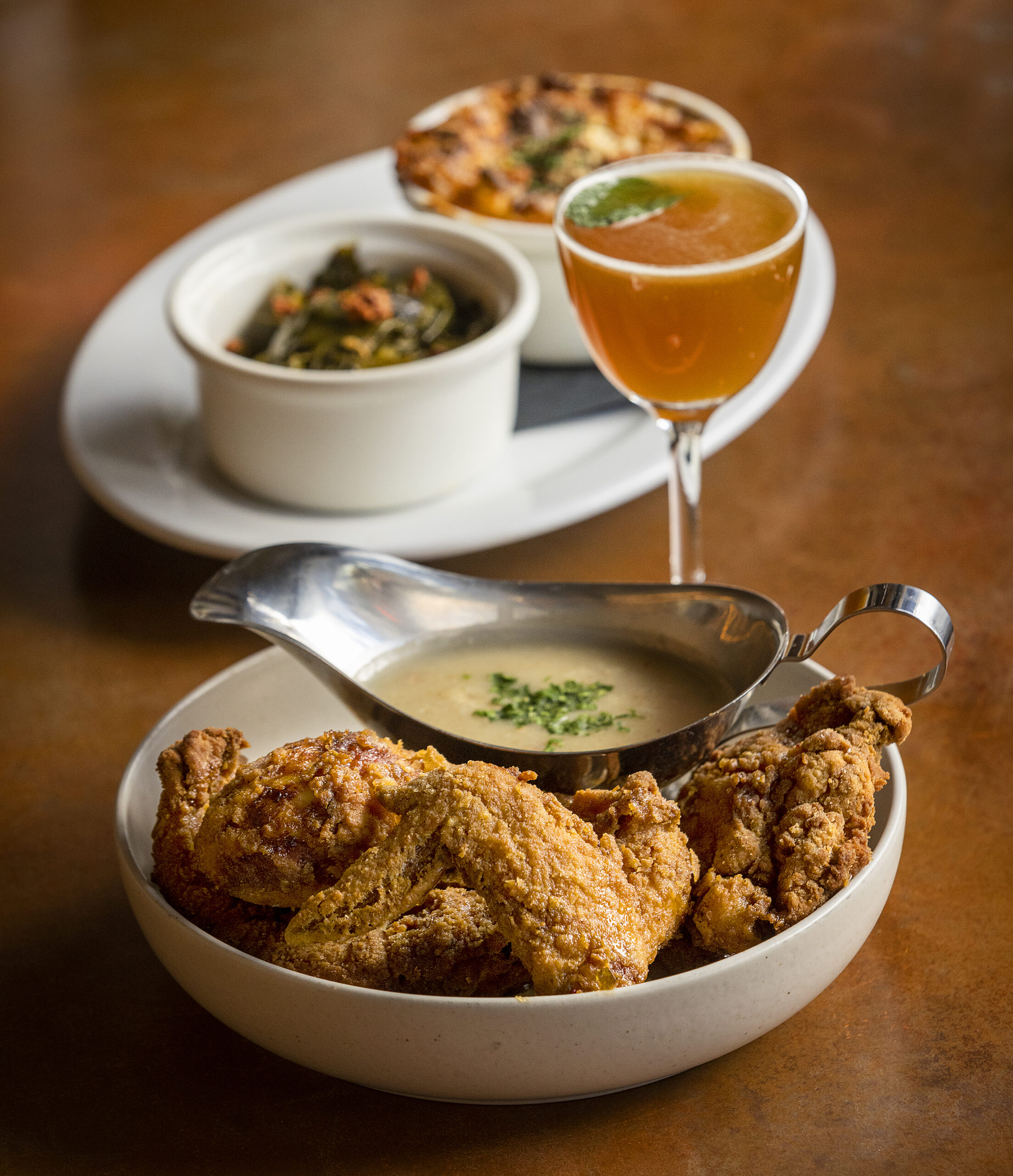 Southern Fried Chicken Dinner with leftover collards, mac n cheese, bacon truffle gravy and Calabrian chili honey with The Derby Cocktail from Easy Rider in Petaluma. (John Burgess/The Press Democrat)