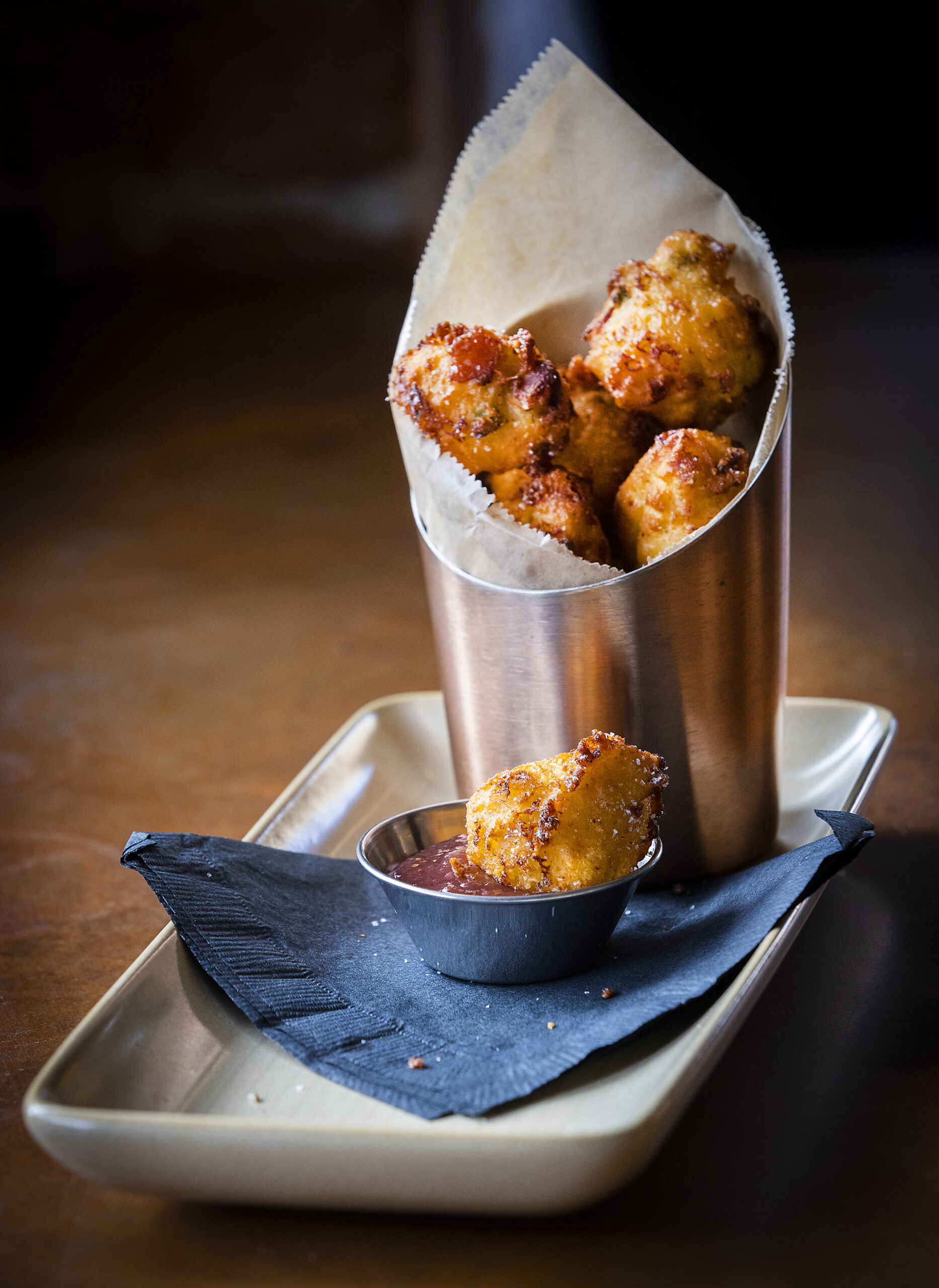 Bacon + Cheddar Hushpuppies with strawberry/ jalapeño jam from Easy Rider in Petaluma on Tuesday, March 1, 2022. (The Press Democrat Staff)