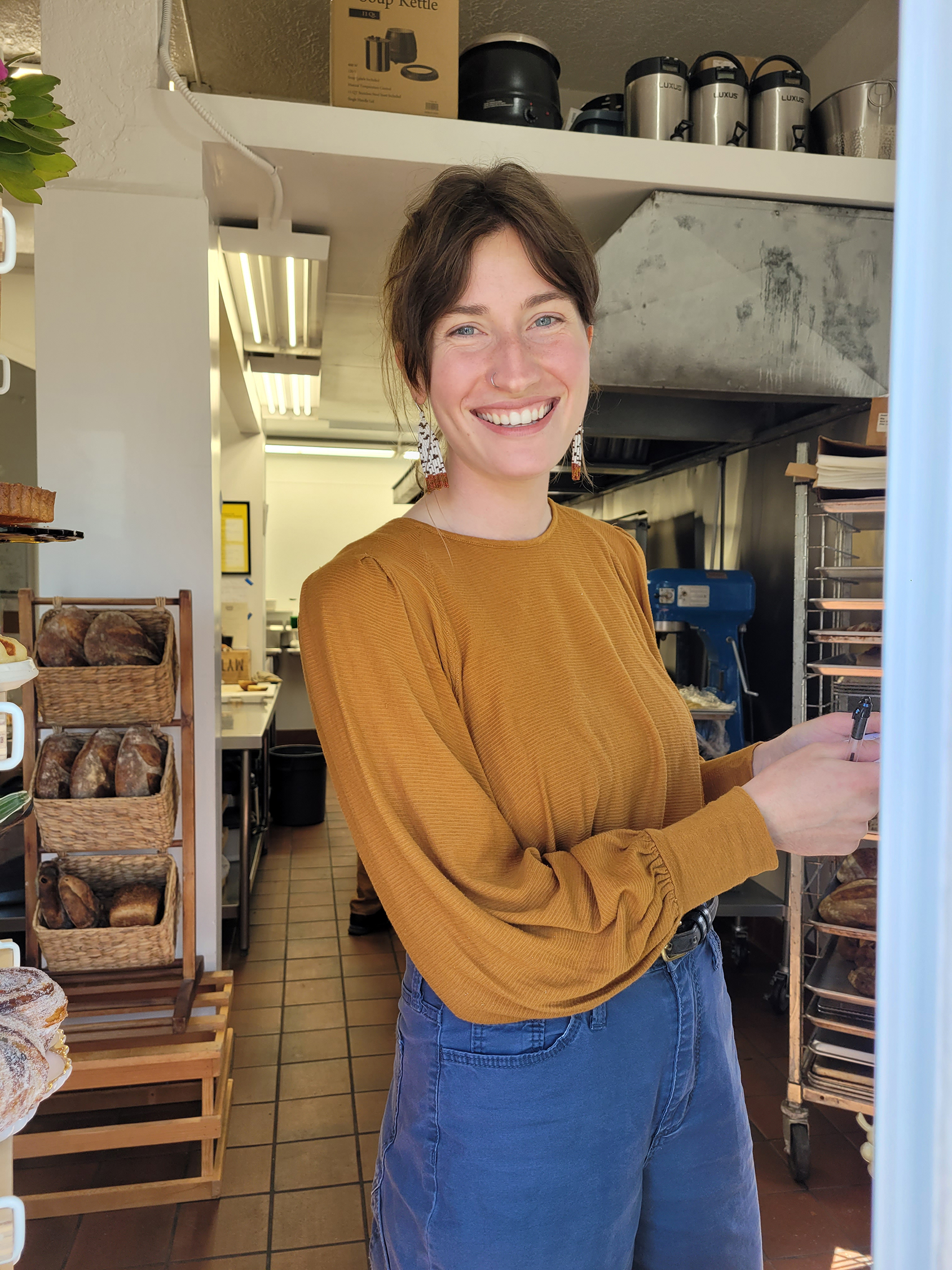 Libby Howard of Sonoma Mountain Breads welcomes guests at the secret window. (Heather Irwin/Sonoma Magazine)