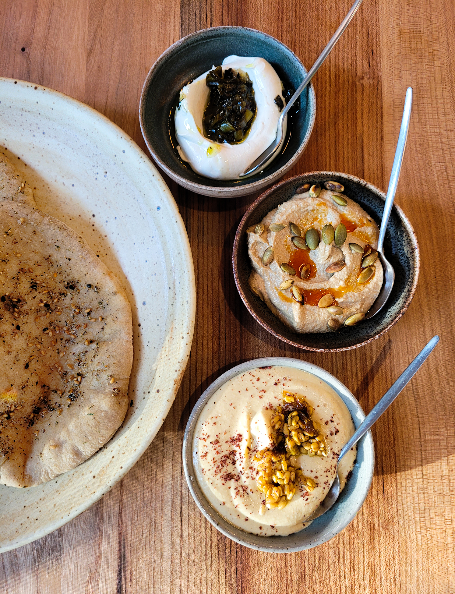 Cultured cashew spread, pumpkin seed dip, red lentil hummus with soft lavash at Little Saint in Healdsburg. (Heather Irwin/The Press Democrat)