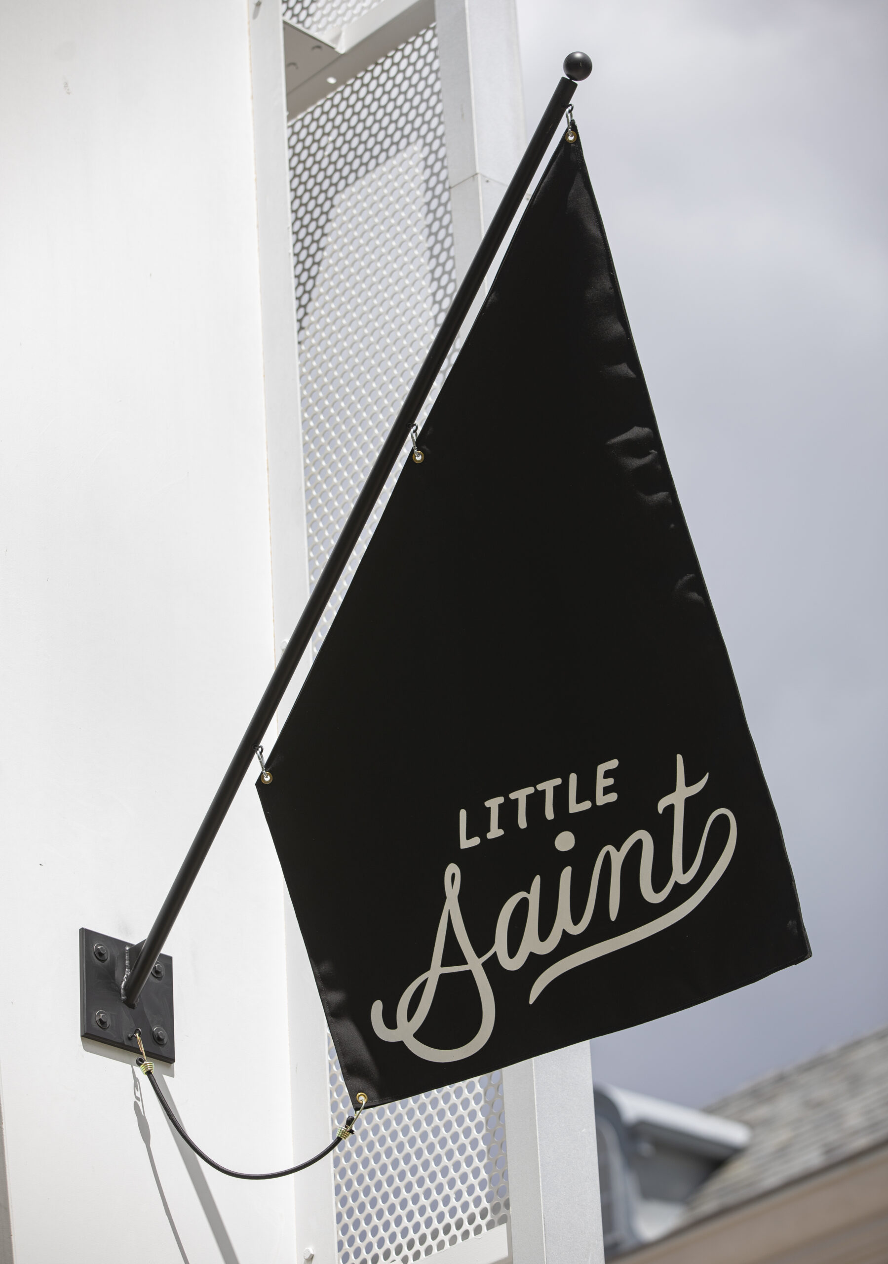 A flag graces the exterior of Little Saint during FridayÕs grand opening in downtown Healdsburg on April 22, 2022. (Chad Surmick / The Press Democrat)