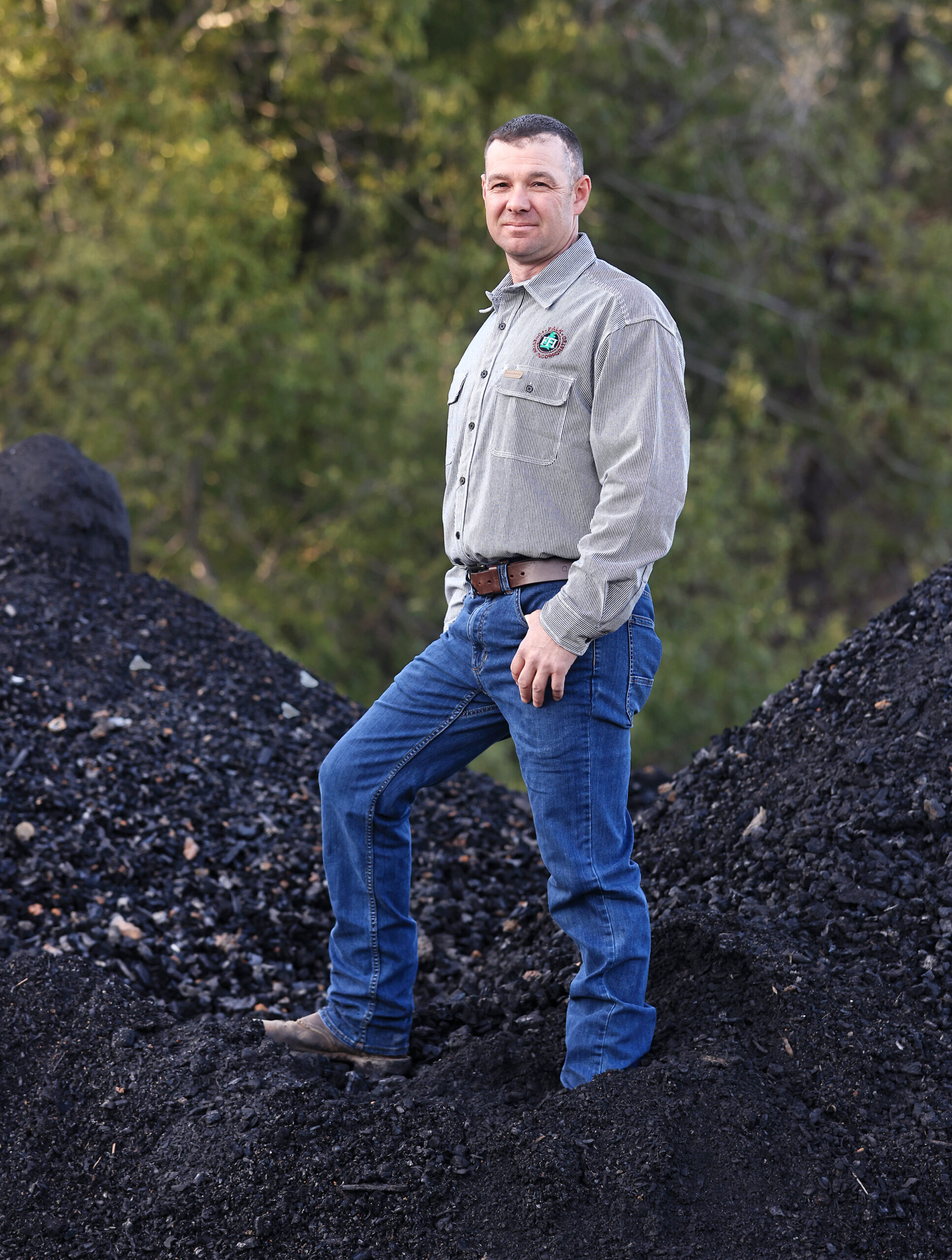 Dan Falk, fifth generation Sonoma County resident standing on a large large mound of biochar, Thursday, Jan. 13, 2022. Falk purchased a Tiger Cat Carbonizer, a machine the processes a large amount of wood and slash at the right temperature to create biochar. (Kent Porter / The Press Democrat) 2022