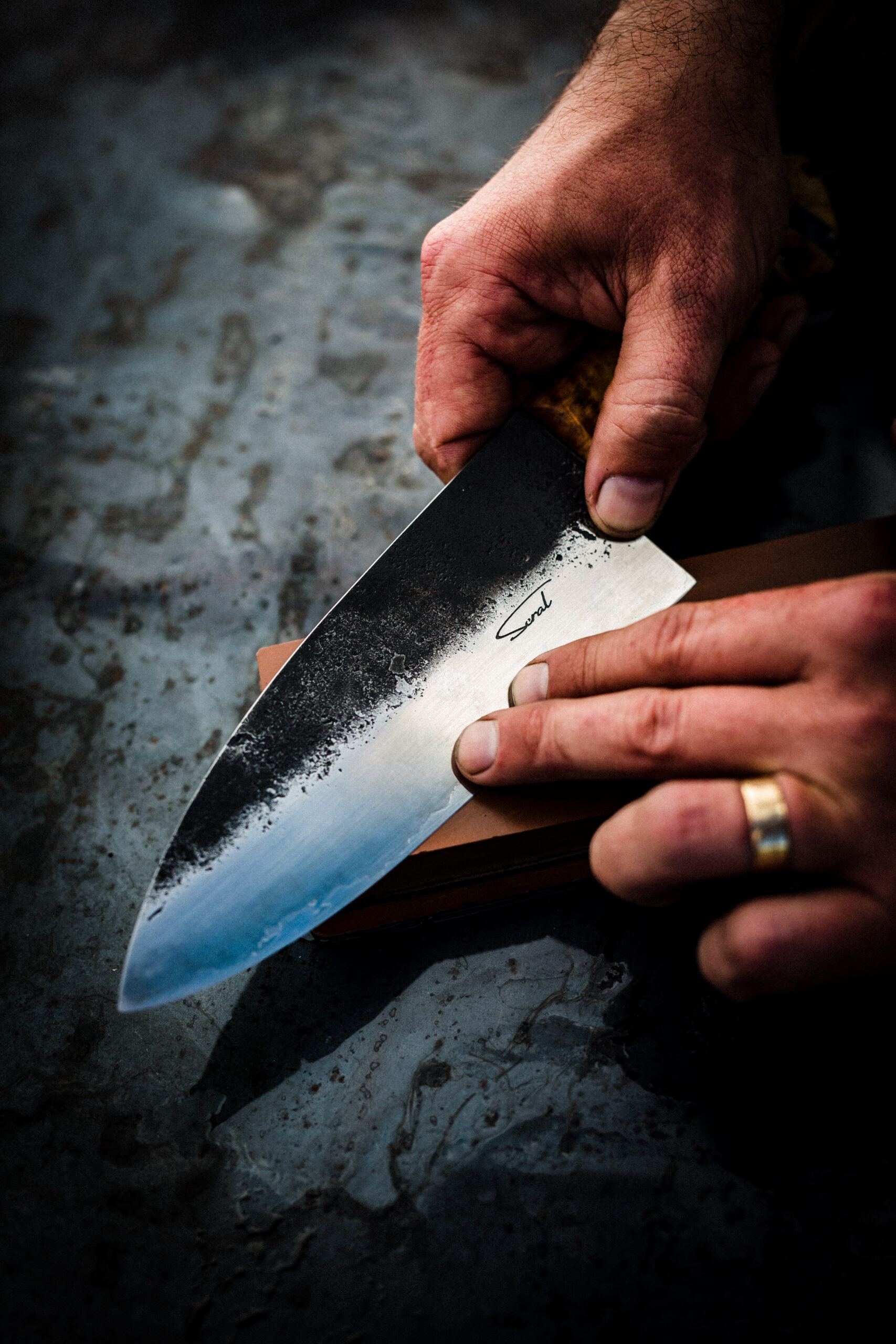 The grain on each blade comes from the fusing of two metals: a stainless steel outer “jacket” and a high-carbon core that can hold a sharp edge. (John Troxell)