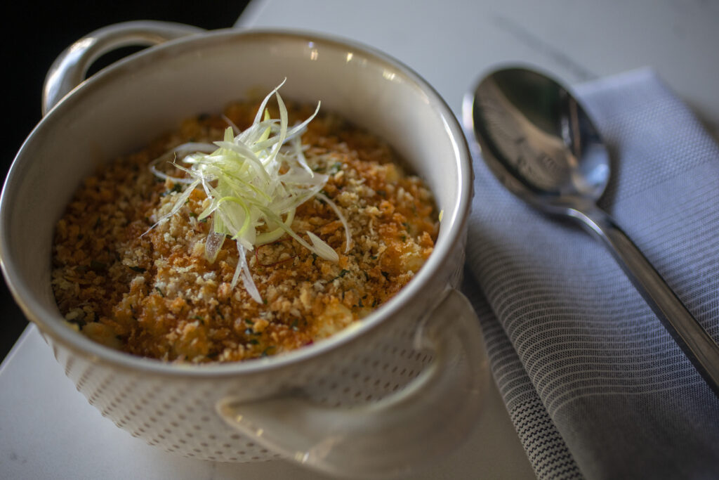 Very adult Mac & cheese - Huancaina sauce, herb bread crumbs, and chili oil, pork belly and crab can be added at Kancha Champagne Bar & Tapas in downtown Santa Rosa Tuesday June 14, 2022 (Chad Surmick / Press Democrat)