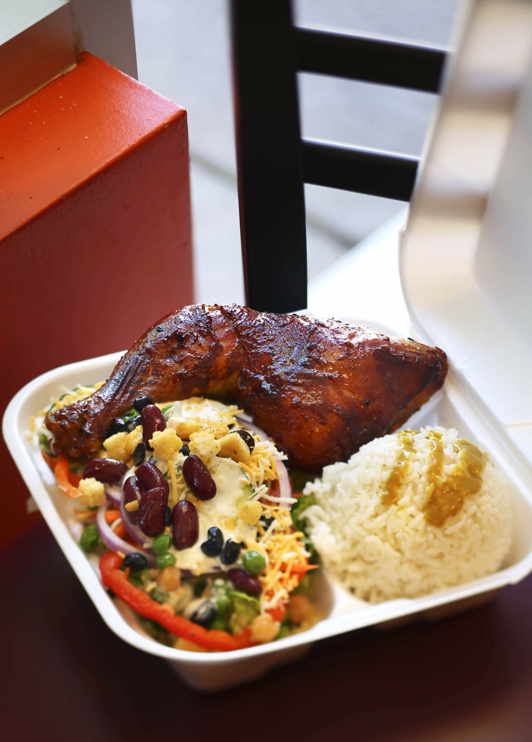 Barbecue chicken with a salad and curry rice is served for only  at Red Bee BBQ in Santa Rosa on Thursday, April 10, 2014. (Conner Jay/The Press Democrat)