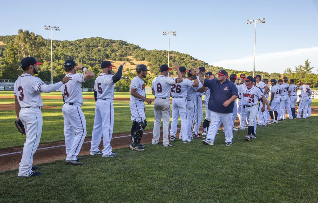 Walking the line with the team are manager Zack Pace and pitching coach Mike Nunez. Opening night for Sonoma Stompers baseball was at Palooza Park on Arnold Field Saturday, June 1. (Photo by Robbi Pengelly/Index-Tribune)