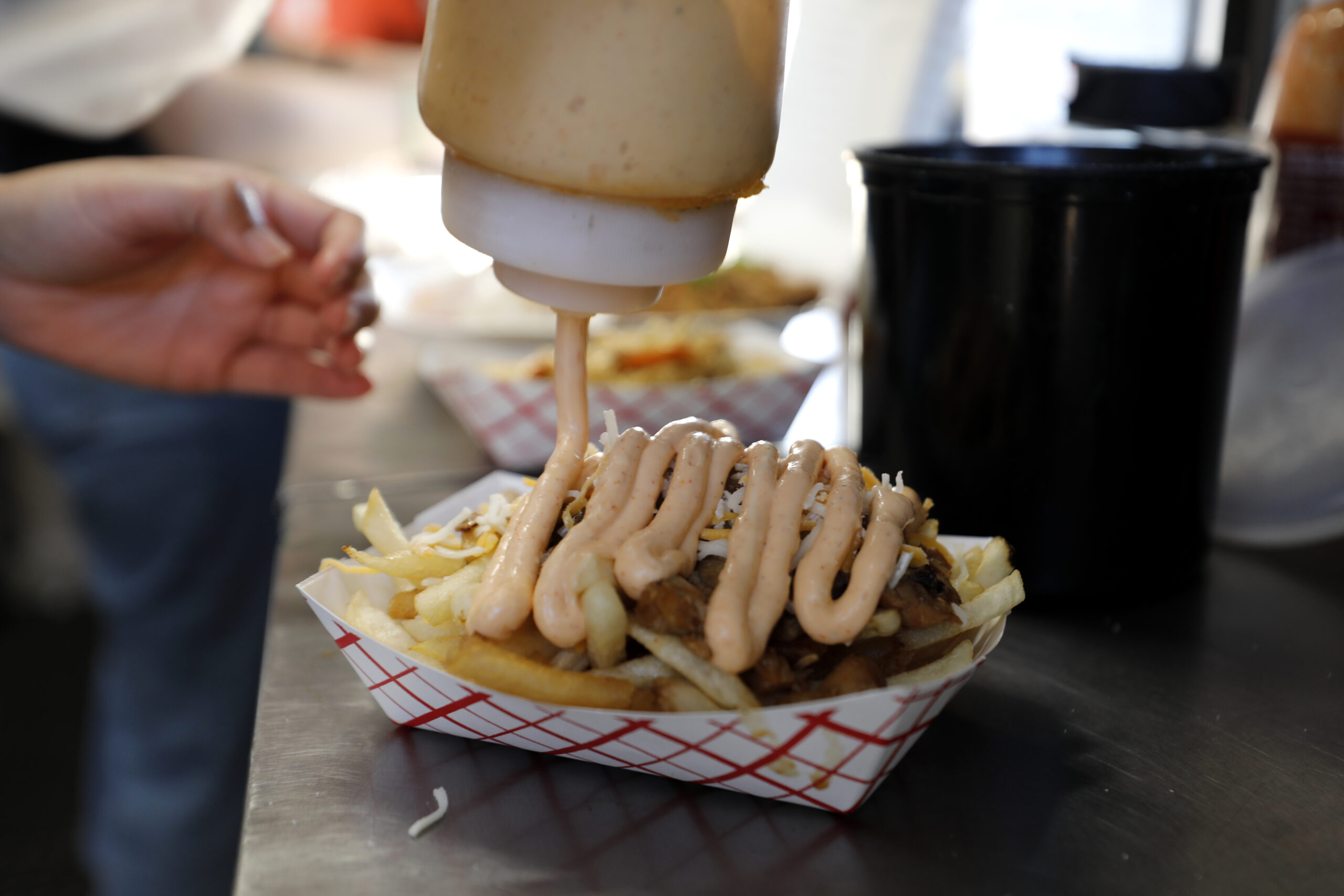 Adobo fries prepared at Adobos ’N More's famous adobo fries. (Beth Schlanker/The Press Democrat)