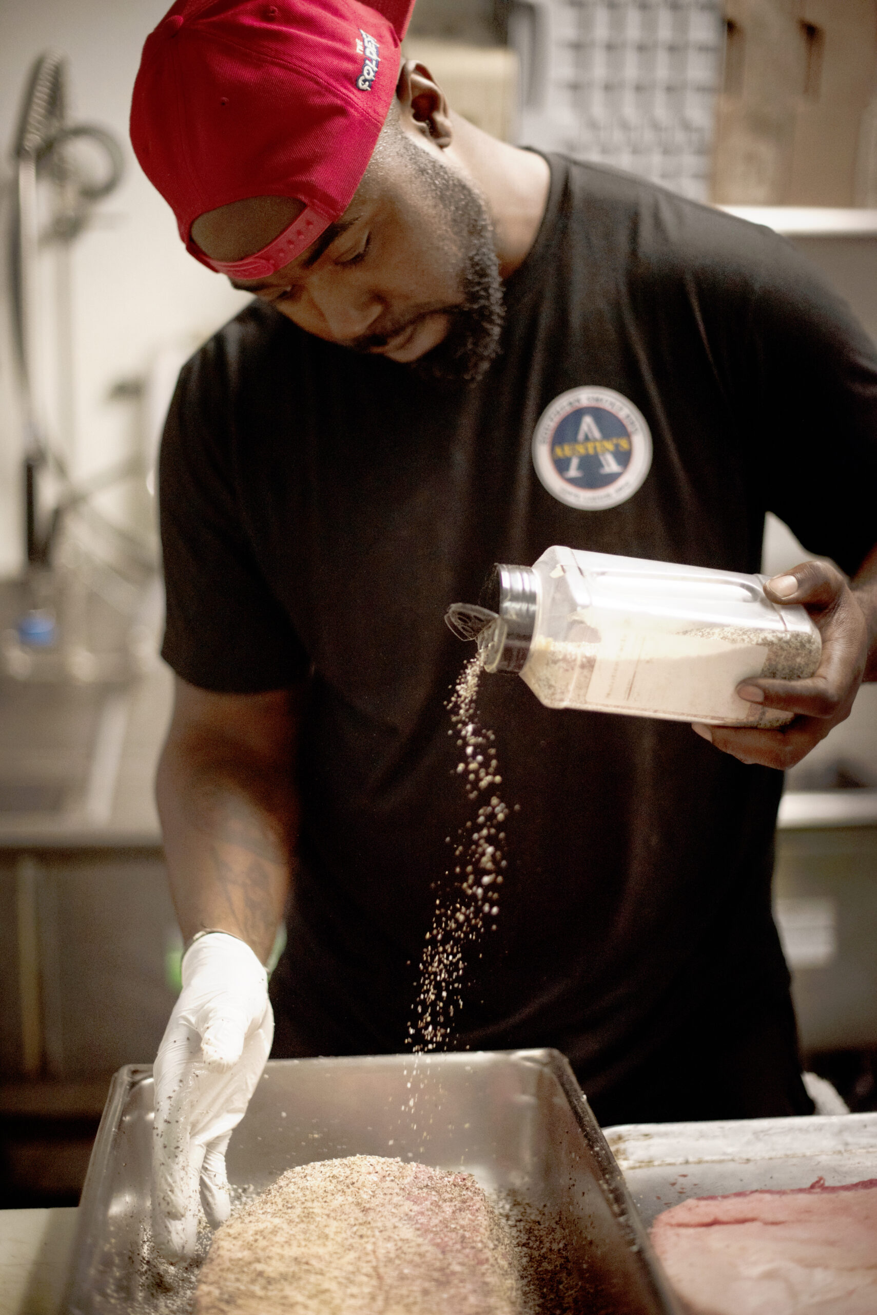 Kris Austin of Austin's Southern Smoke BBQ seasoning his brisket cuts with kosher salt and black pepper at Old Possum Brewing Co. in Santa Rosa, California on May 5, 2022. (Photo: Erik Castro/for Sonoma Magazine)