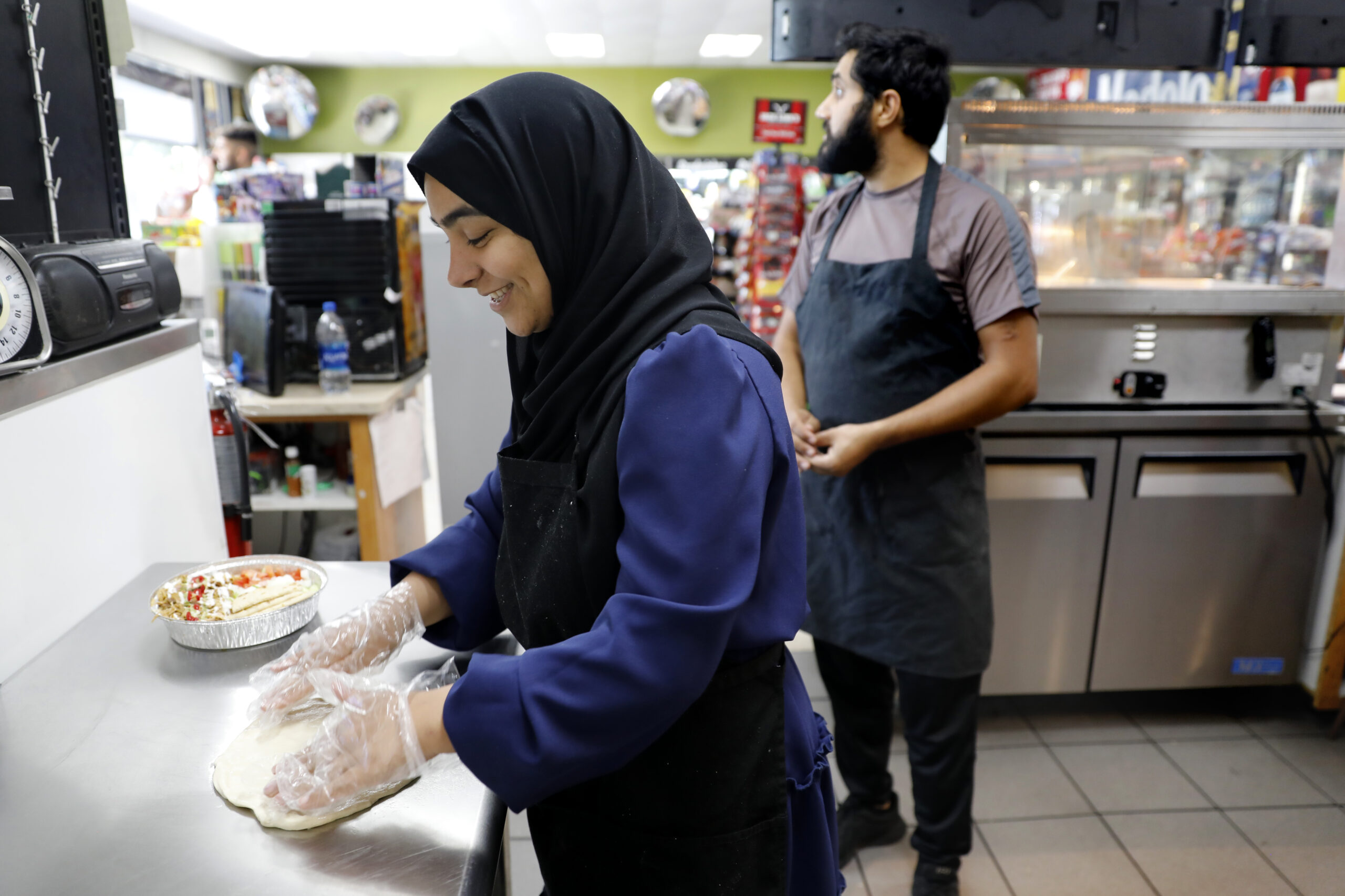 Saida Noore makes fry bread at ZamZam in Santa Rosa, Calif. on Monday, July 25, 2022. (Beth Schlanker/The Press Democrat)