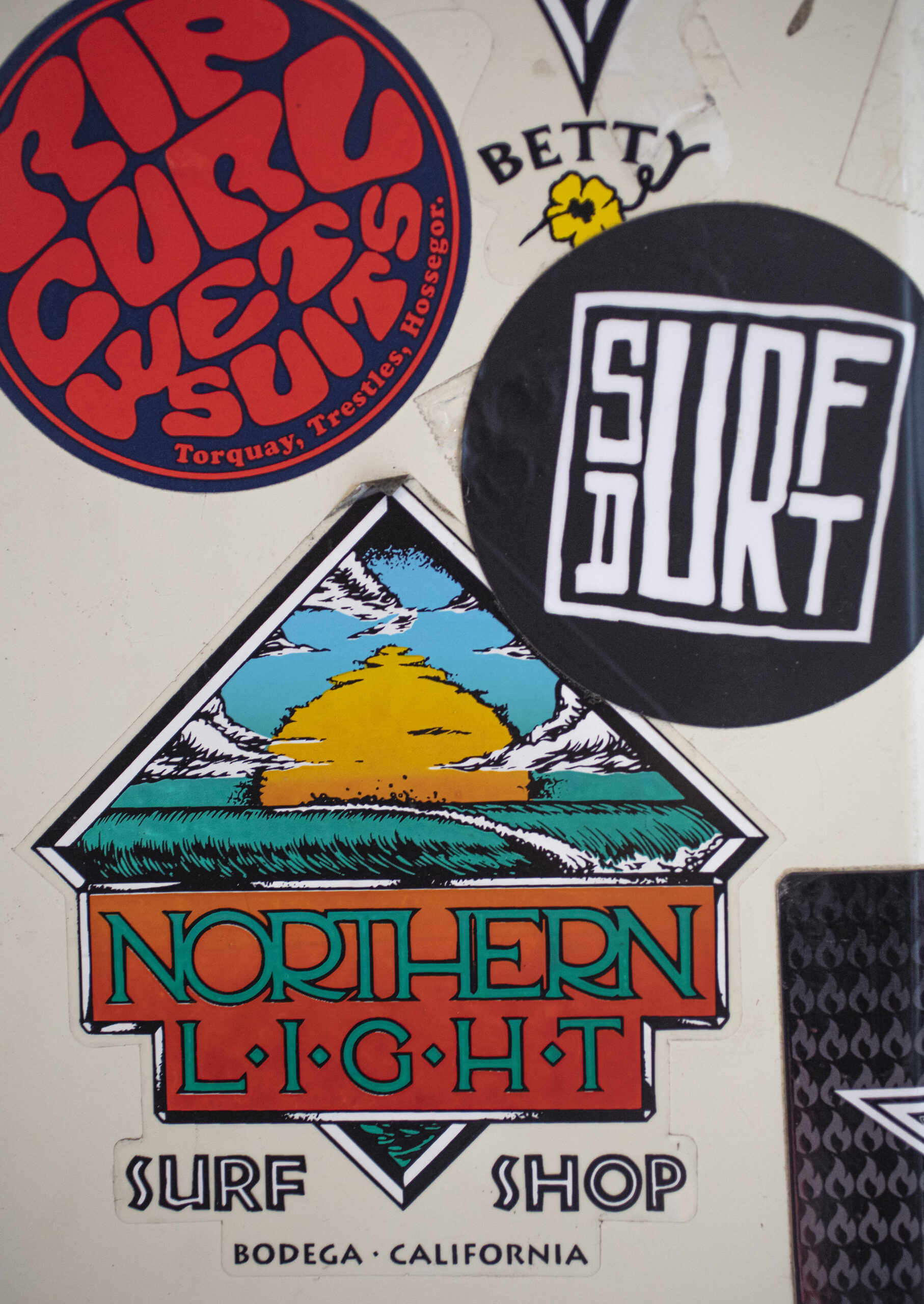 Stickers adorn Northern Lights Surf Shop Sin Bodega.(Chad Surmick / The Press Democrat)
