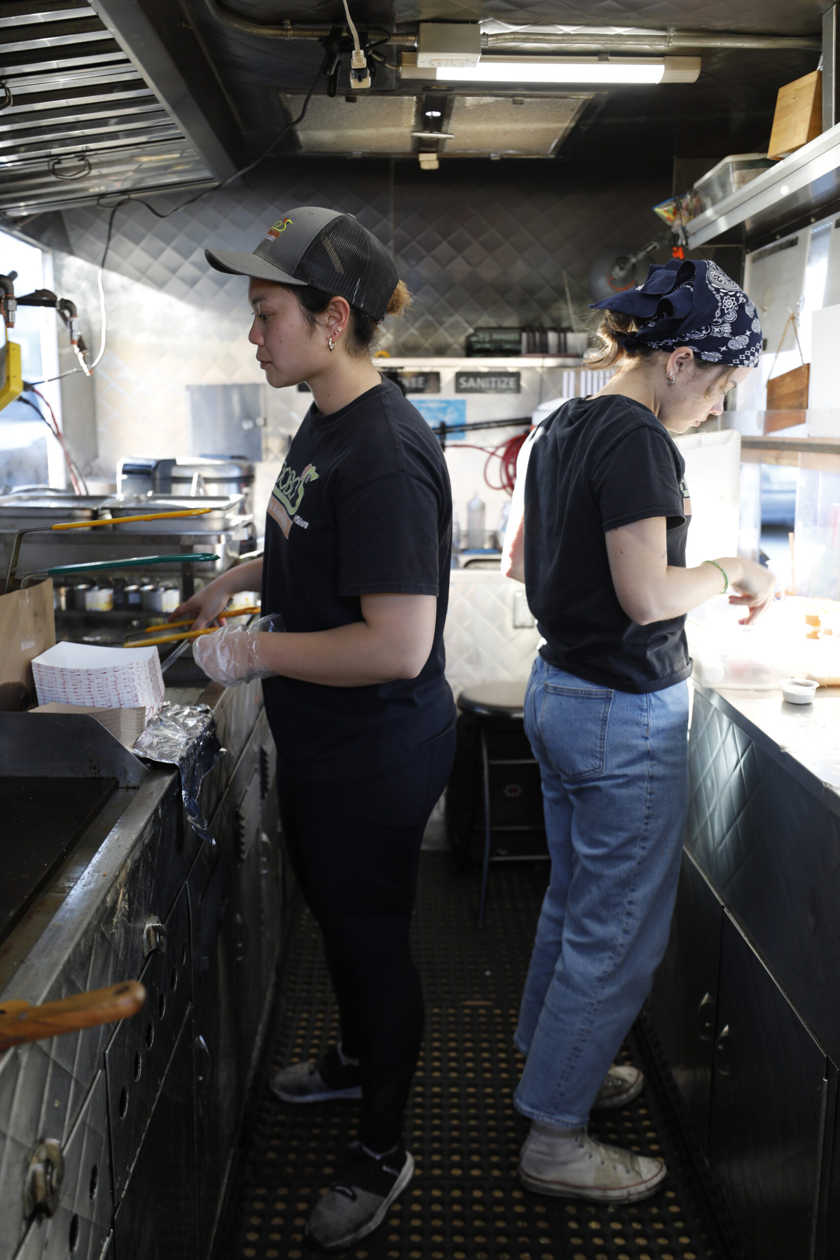 Adobos N' More food truck owner Hannah Huyoa, left, at The Block Petaluma food park in Petaluma, Calif., on Saturday, May 14, 2022.(Beth Schlanker/The Press Democrat)