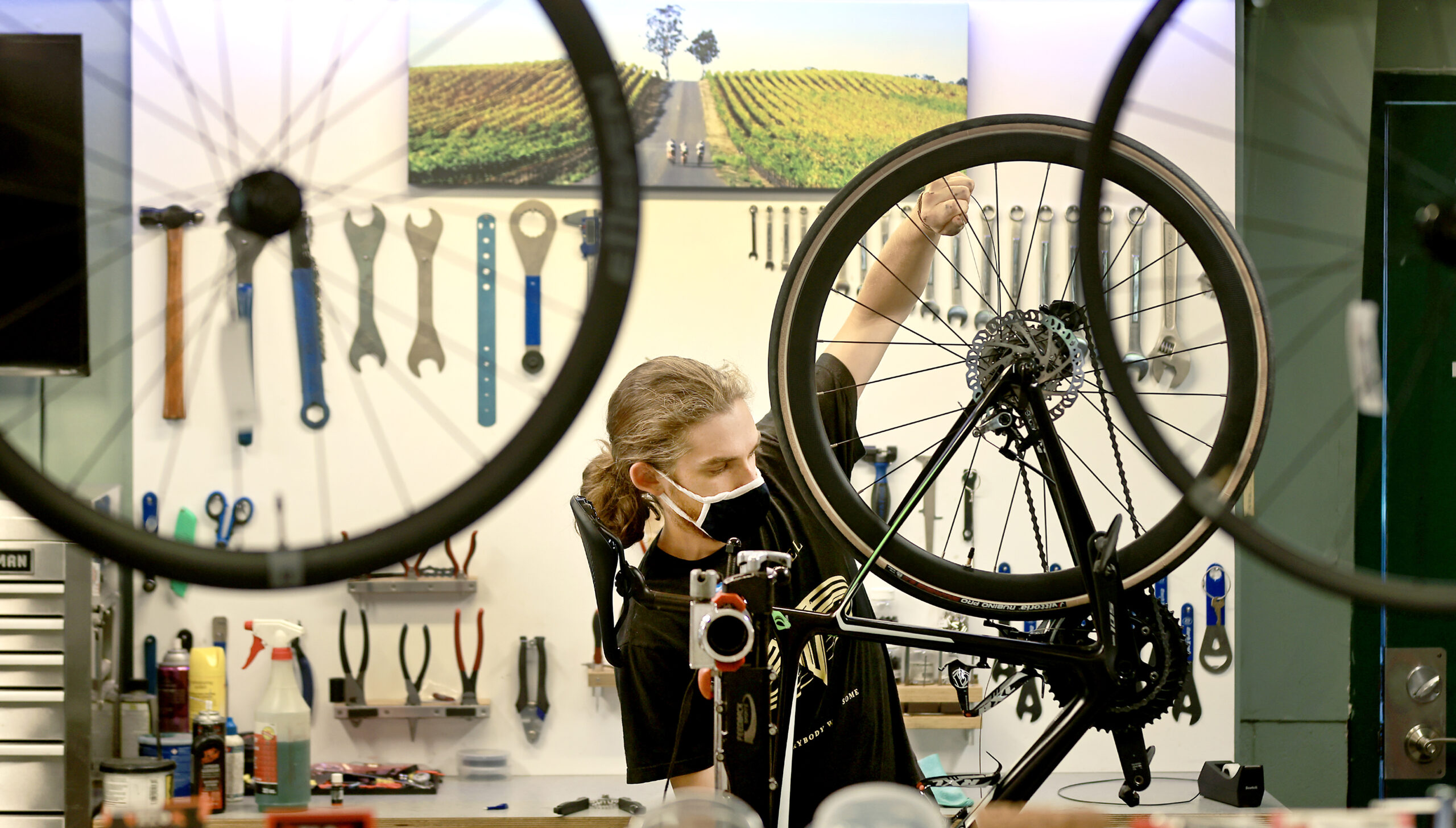 Spoke Folk bike mechanic Drew Merritt installs new cabling. (Kent Porter / The Press Democrat)