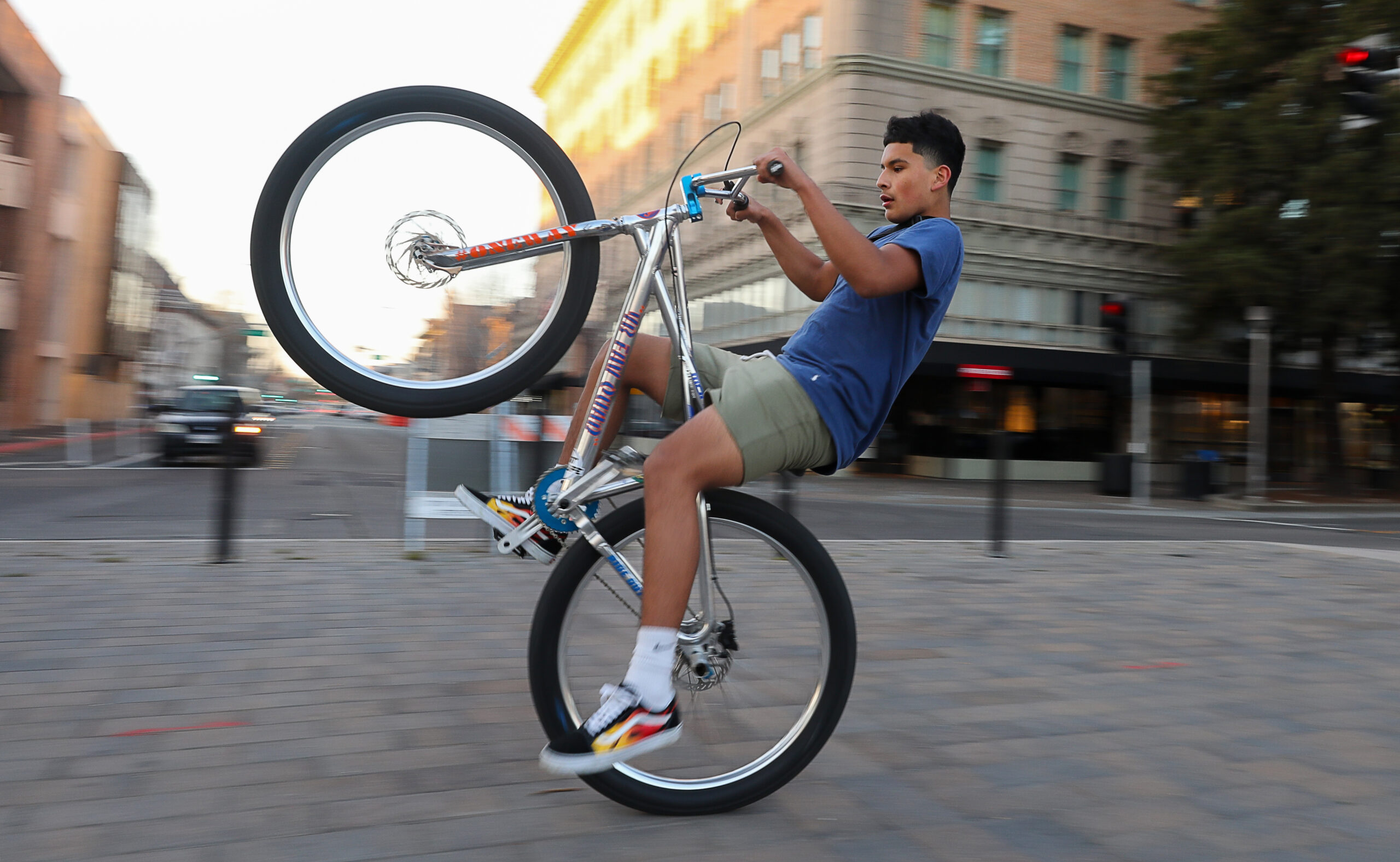 Alex Rodriquez performs a wheelie on his bike while riding around with his friends at Old Courthouse Square in Santa Rosa on Thursday, March 4, 2021. (Christopher Chung/ The Press Democrat)