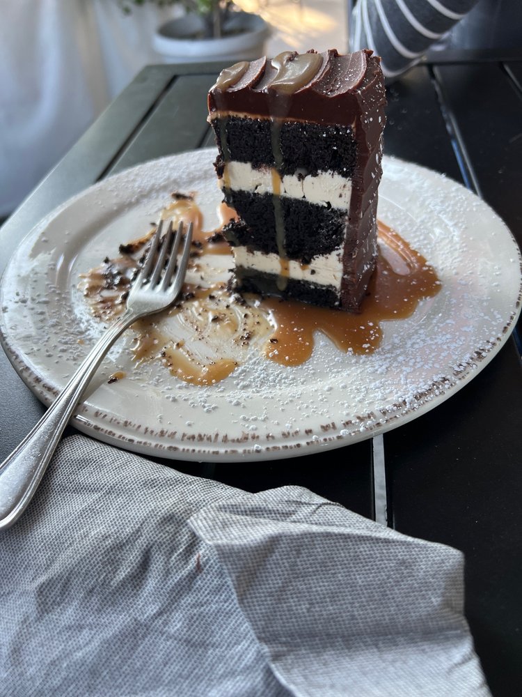 Wild Goat Bistro, Sea Salted Caramel Cake: Gluten-free chocolate buttermilk cake with buttercream and a salted caramel filling, coated in a rich chocolate ganache and a salted caramel drizzle. (Courtesy of Pam M. on Yelp)