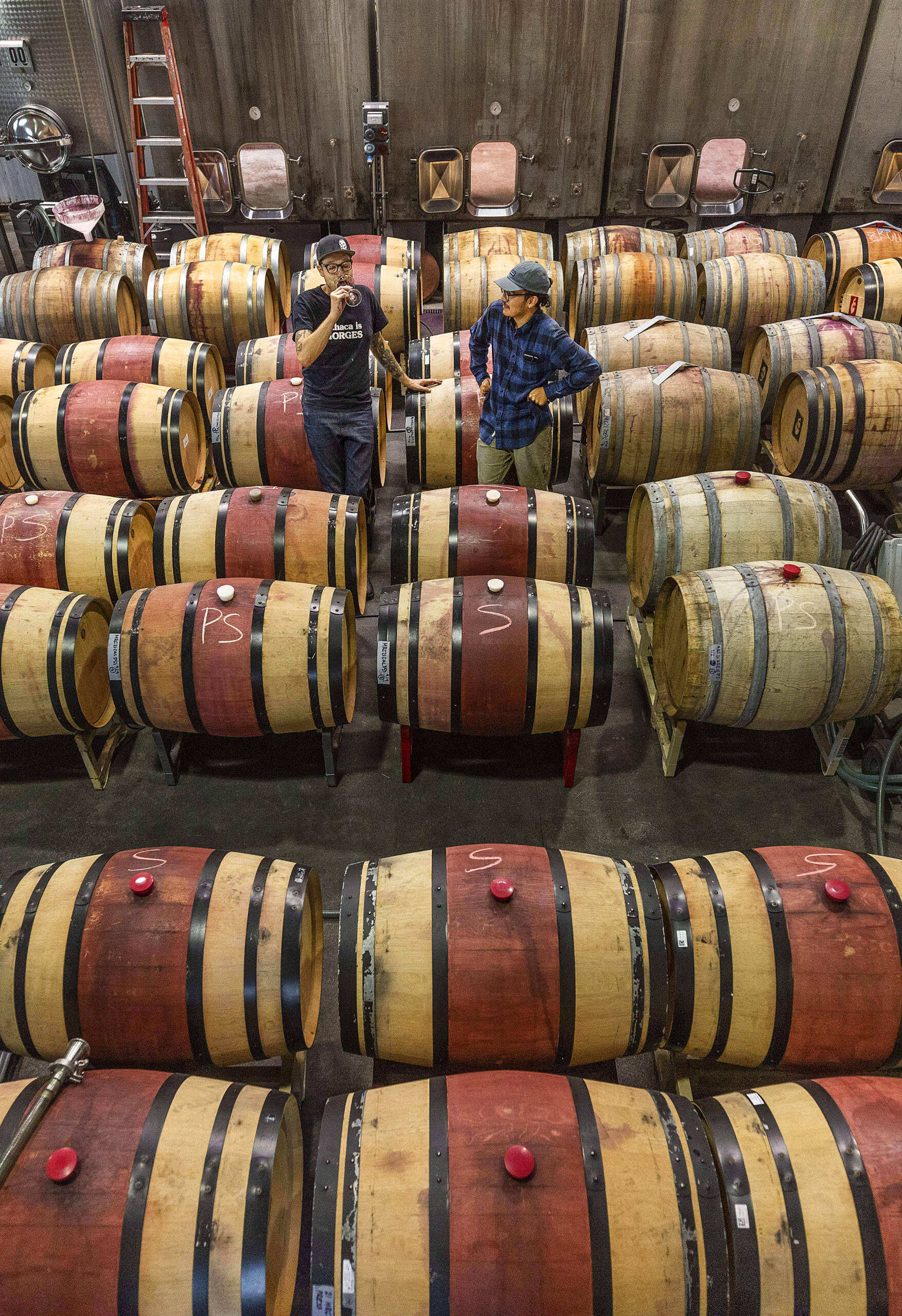 Monte Rio Cellars owner/winemaker Patrick Cappiello, right, and assistant Jesus Aleman take a break to sample a blend in the Pax Wines' winemaking facility at The Barlow in Sebastopol. (John Burgess/Sonoma Magazine)