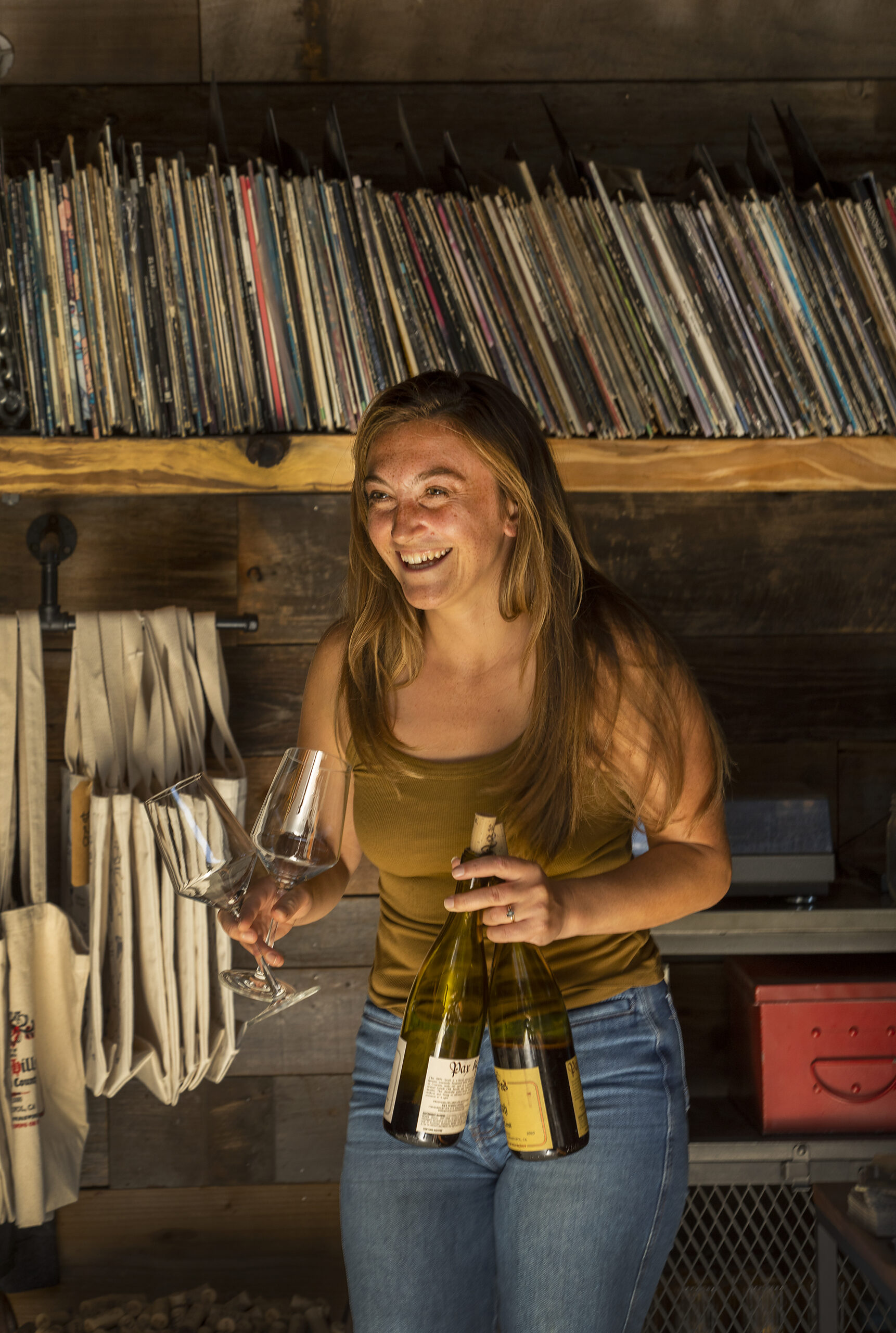 Server Lauren Kelly bring wine to guests at the Pax Winery tasting room at The Barlow in Sebastopol. (John Burgess/Sonoma Magazine)