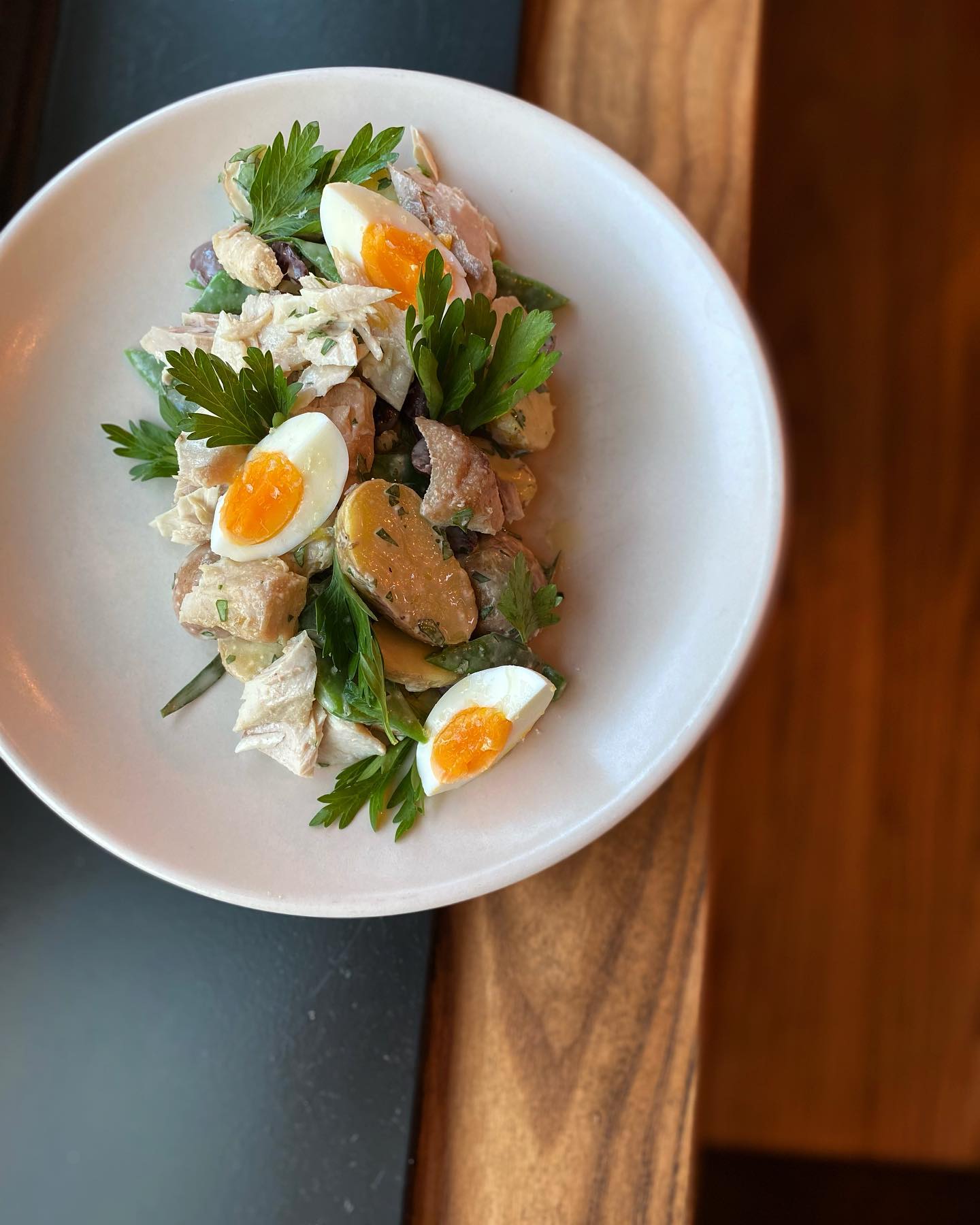 Salad Nicoise from The Redwood with Albacore confit, pinto gold potatoes, romano beans, olives, tarragon, parsley, 7-minute egg and colatura vinaigrette. (The Redwood)
