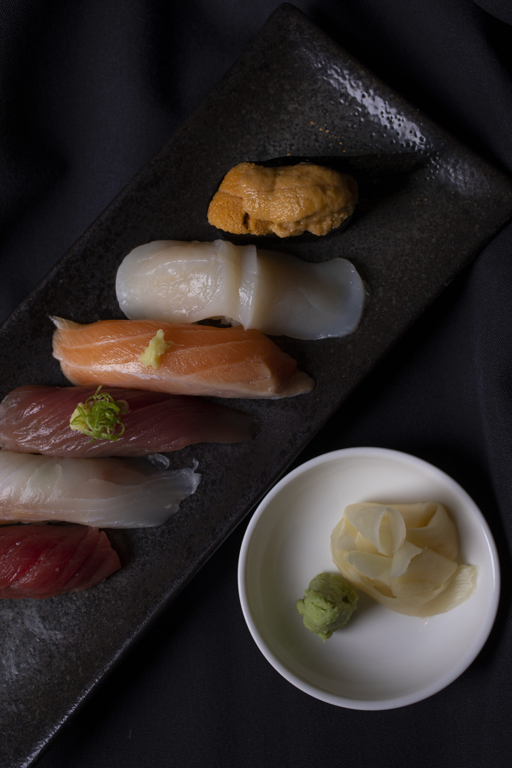 Keita Tominagas Chef choice from bottom omakase nigiri, hon-maguro, ishigakidai, katsuo, iwana, hotate, and uni at Hanna Japanese Restaurant in Rohnert Park September 21, 2022. (Chad Surmick / The Press Democrat)