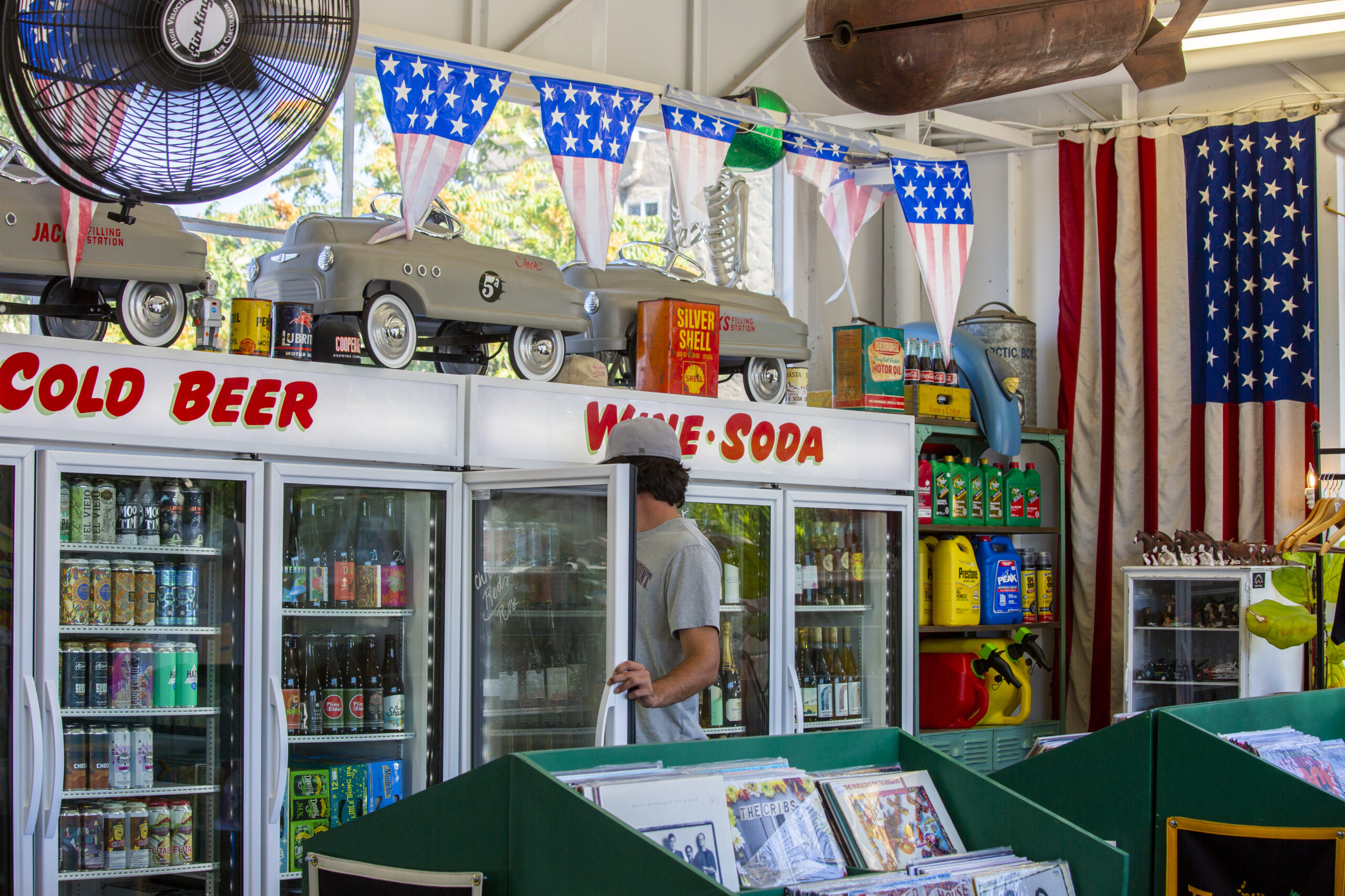 Beer, wine and sodas are staples at Jacks Filling Station on Broadway, which sells gas, vintage vinyl records, and an assortment of sundries. The retro vibe is prominent throughout the building, and there are many small still lives scattered around the store, on Thursday, June 24, 2021.(Photo by Robbi Pengelly)