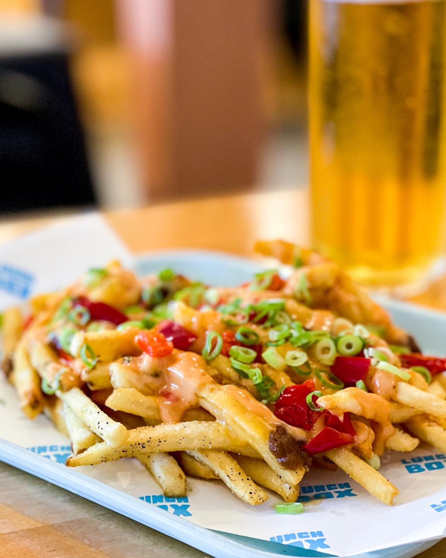 Crispy fries smothered in American cheddar, onion butter, fancy sauce, peppers and green onions. (Courtesy of Lunch Box)