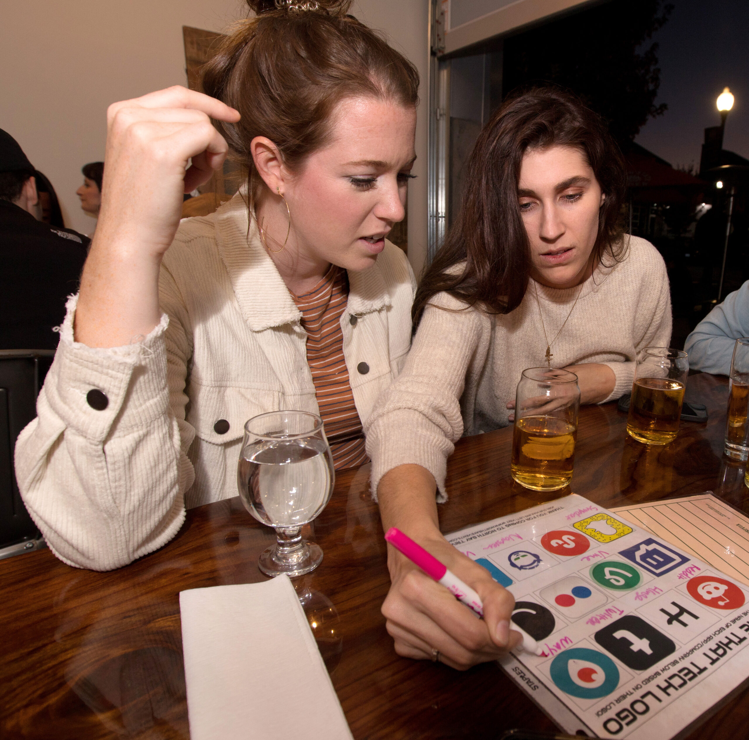 From left, Pierce Neitzke, and Lauren Holt, both of Austin, Texas, answer trivia questions during trivia night presented by North Bay Trivia at Golden State Cider Taproom, Thursday, October 13, 2022, in Sebastopol. (Darryl Bush / For The Press Democrat)
