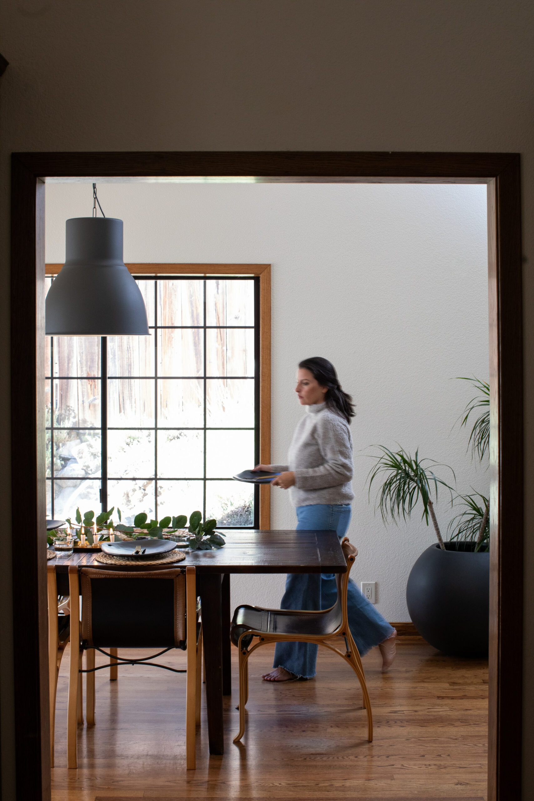Designer Catalina Marin, owner of a Healdsburg company that imports textiles from her native Chile, sets the table with simple, handthrown ceramics and eucalyptus branches. (Eileen Roche)