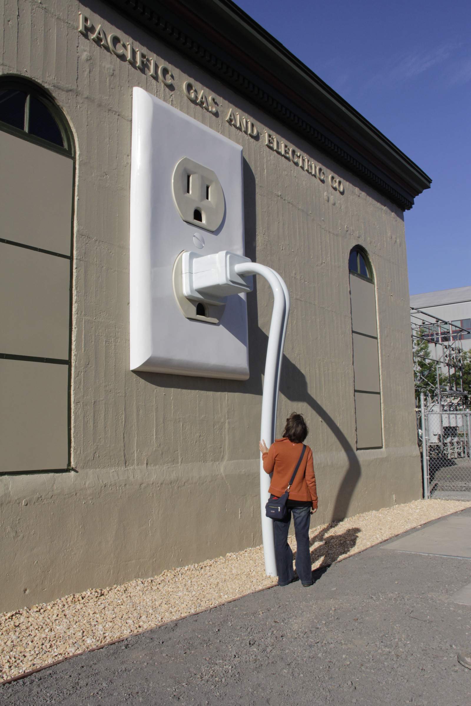 Daya Ceglia checking out the Plug during the unveiling reception of a sculpture by fabricator Shawn Thorsson and artist Joel Jones at the1st and D Street PG&E substation in Petaluma on Friday, July 10, 2015. (Jim Johnson/For the Argus-Courier)