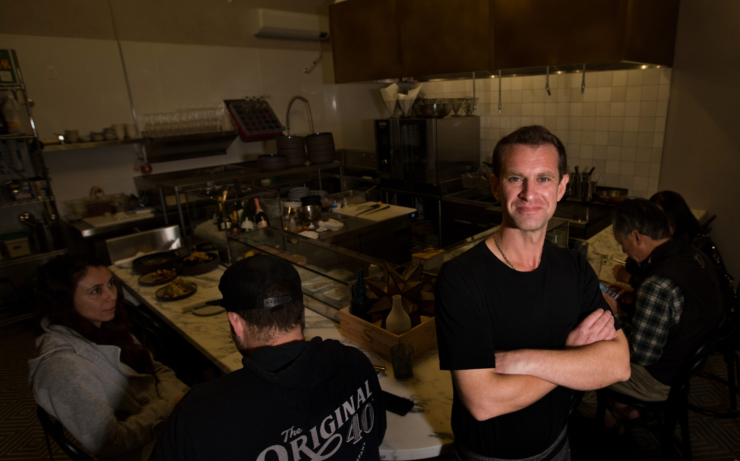 Chef Jake Rand stands inside of Oyster, a new restaurant in The Barlow, with guests in the background, Monday, November 7, 2022, in Sebastopol. (Darryl Bush / For The Press Democrat)