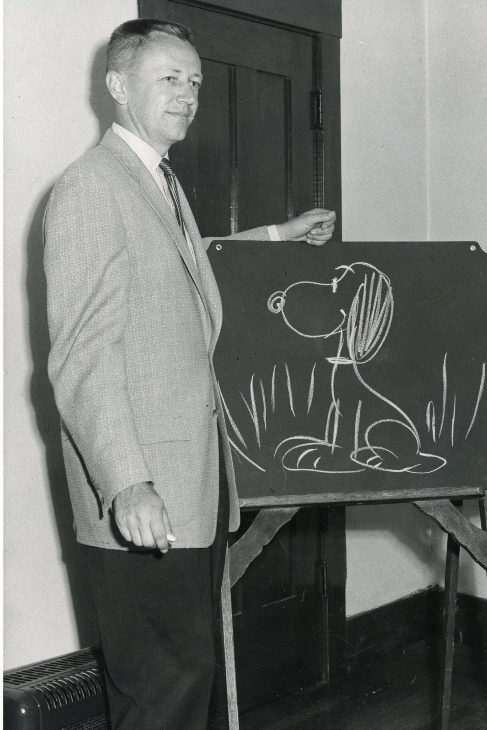 A circa-1960s image of a young Schulz demonstrating how to draw his most famous character.
