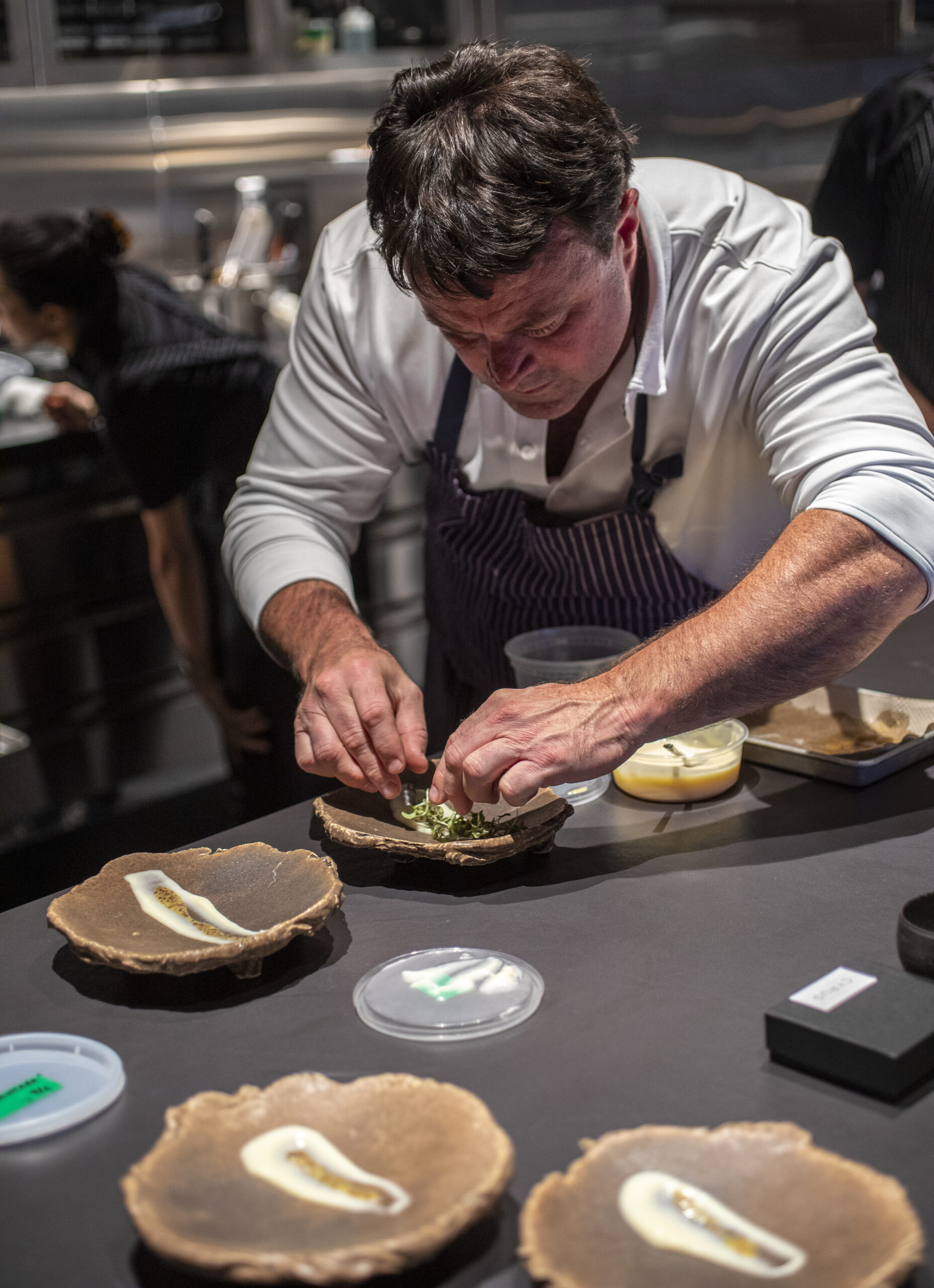 During a family and friends pre-opening aged gouda, pear, pretzel and mustard are plated for service by Chef Doug Keane at Cyrus in Geyserville on Thursday September 8, 2022. (Chad Surmick / Press Democrat)