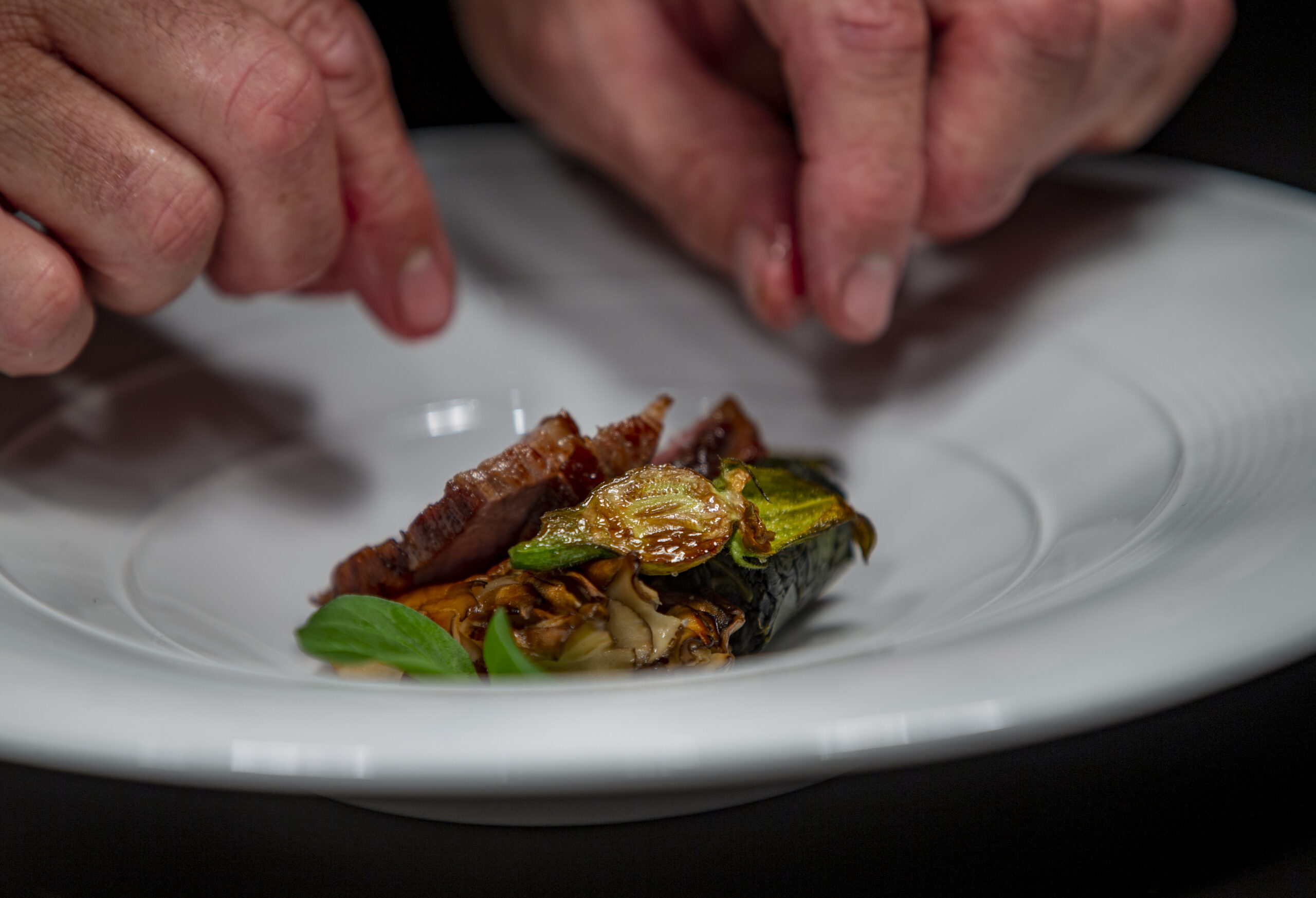 Sonoma Duck, Kosui pear and turnips are plated for service at Cyrus in Geyserville. (Chad Surmick / The Press Democrat)