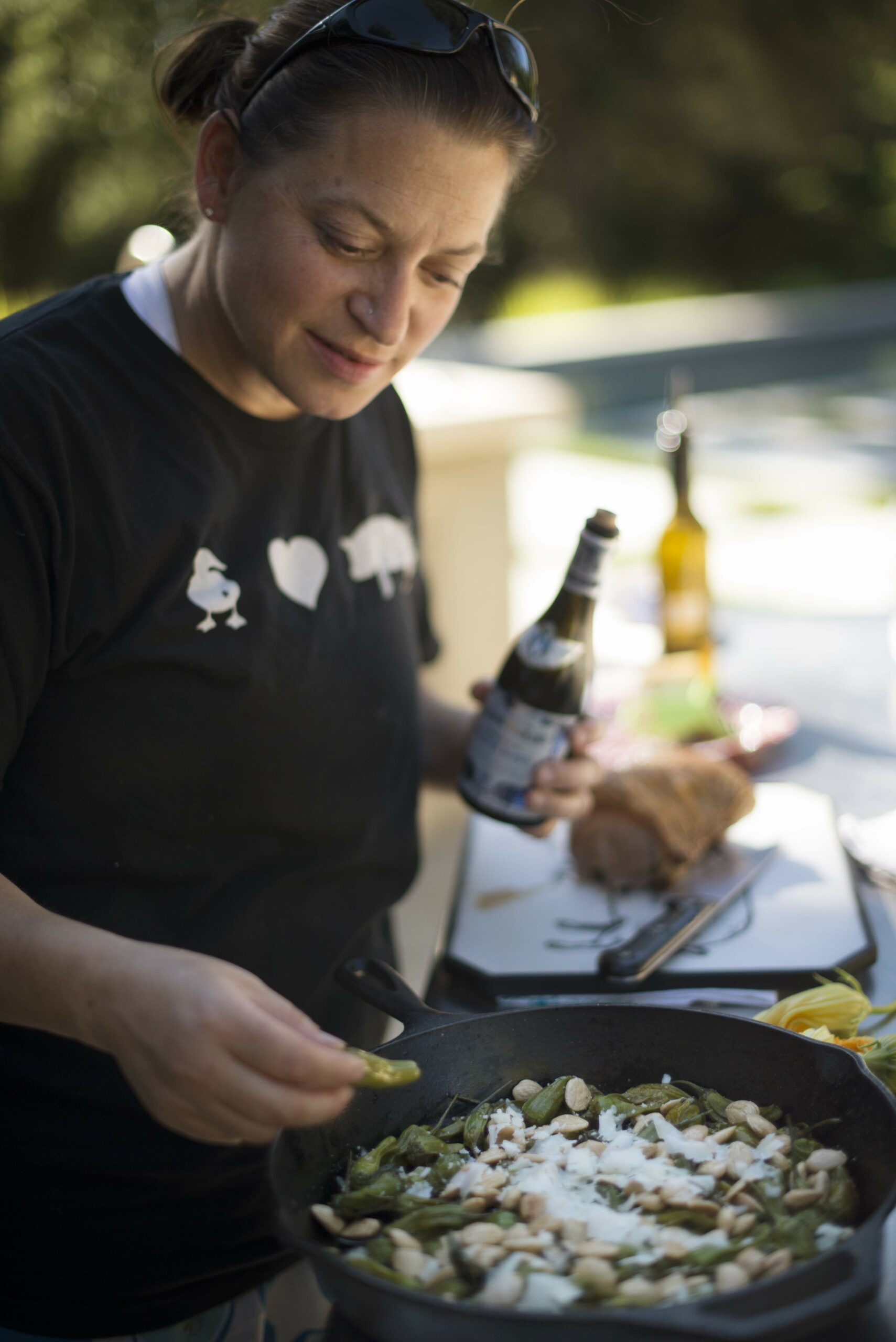 Duskie Estes tasting her wood-fired roasted shishito peppers with Marcona almonds and shavings of Pennyroyal Farm Boont Corners cheese alongside an arugula salad at her home in Forestville, California. June 18, 2016. (Photo: Erik Castro/for Sonoma Magazine)