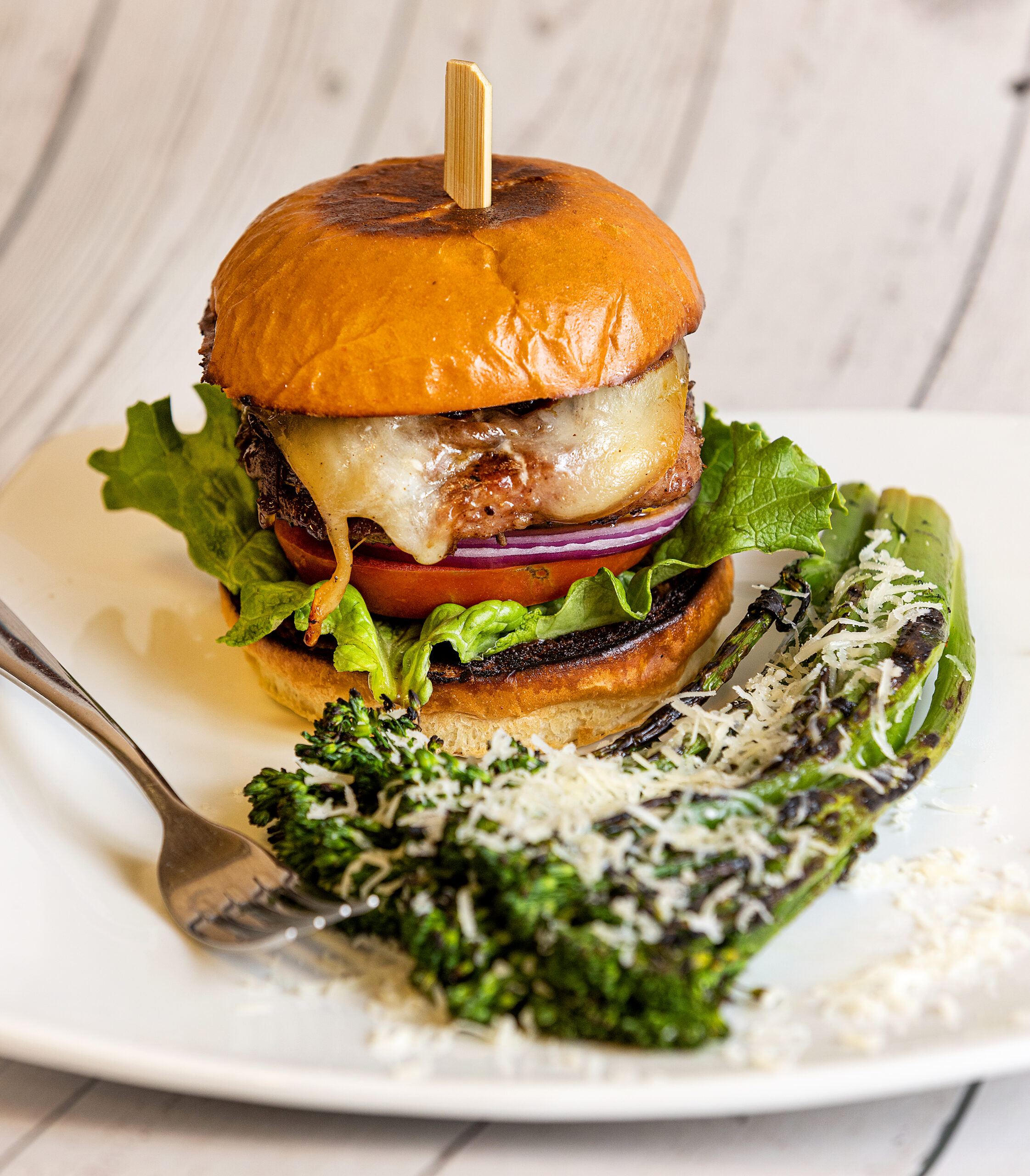 The ÒRealÓ Hamburger (Pork) with a side of Grilled Broccolini from Vine Burgers in Santa Rosa Wednesday, January 11, 2023. (John Burgess/The Press Democrat)